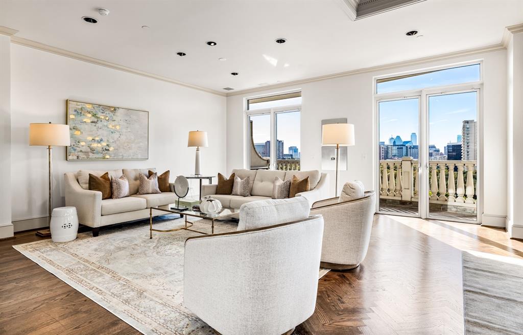 Step off the elevator directly into this stunning 8th-floor residence at The Vendome, elevated above the treetops of Turtle Creek. Hardwood floors lead through a gorgeous entry into the open dining and living area, complete with a fireplace and a spacious balcony showcasing downtown skyline and park views. The breakfast lounge flows seamlessly into the chef’s kitchen, featuring a large island, Sub-Zero refrigerator-freezer, and a commercial-grade gas cooktop—ideal for entertaining or everyday luxury. The serene primary suite offers its own balcony, two elegant full baths, and a generous walk-in closet, while the second bedroom is privately situated for comfort. A stylish powder bath serves the main living areas, and a full laundry room sits conveniently near the kitchen. The Vendome provides exceptional amenities, including 24-hour valet, concierge, security, a fitness center, an outdoor heated lap pool and spa, a library, and three fully furnished guest suites—defining luxury living in one of Dallas’s most sought-after high-rises. Includes 3 reserved garage parking spaces (253, 254 and 323)