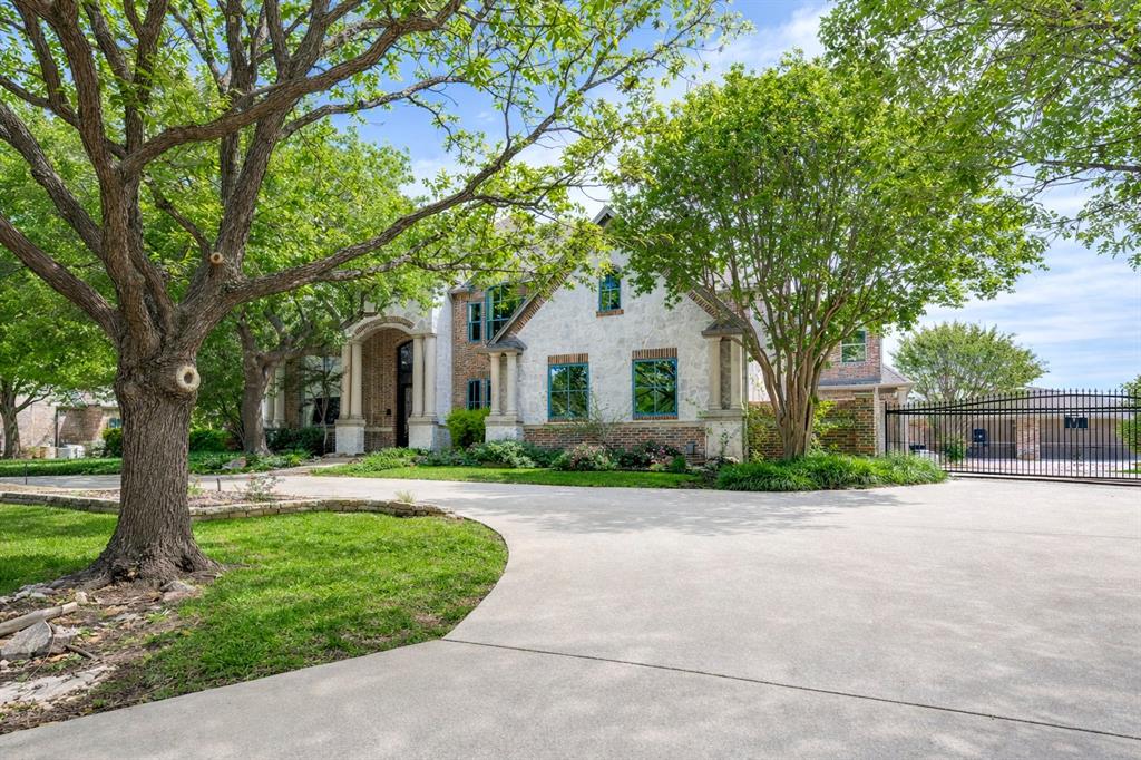 Located in the prestigious North Lake Woodlands community, this extraordinary custom estate offers exceptional design, luxury finishes, and unmatched functionality. A grand circular drive and gated motor court introduce the home, complemented by a seven-car garage, including four air-conditioned bays with high-end flooring, kitchenette, and bath. Inside, a breathtaking two-story entry with a sweeping staircase and rich hardwood floors sets the tone. Elegant formal living and dining spaces showcase refined details, while a beautifully designed study features custom built-ins, a window seat, and abundant natural light. The expansive kitchen is a true showpiece, designed for multiple chefs with an oversized island, commercial-grade cooktop with vent hood, warming drawer, beverage fridge, and Thermador appliances, opening seamlessly to a bright living area and spacious breakfast room. The private first-floor primary suite offers serene backyard views and a fully remodeled spa-inspired bath and dressing room. A secondary bedroom with full bath and private exterior access adds flexibility. Upstairs, three generously sized bedrooms each include en suite baths, along with a large game room featuring a wet bar and balcony, plus an impressive media room. Outdoor living is equally exceptional with a resort-style pool and spa with rock waterfall, outdoor kitchen, and cabana with bath, all surrounded by lush landscaping for ultimate privacy. Award-winning Coppell ISD.