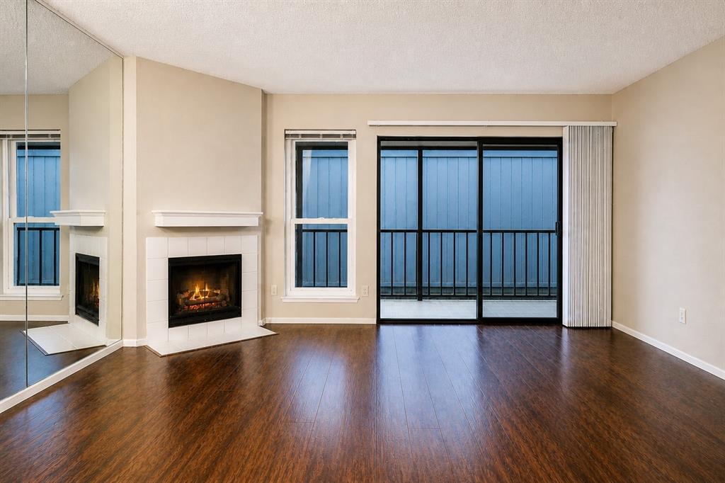 BACK ON MARKET- Buyer unable to close.. Impeccably maintained and well-loved condo is move-in ready and packed with lifestyle perks including gated community, secured access building, two pools, tennis court, and even a dog park. Inside, you’ll find it freshly painted in neutral earth tones with tasteful updates throughout, glossy wood flooring, open-concept layout, cozy wood-burning fireplace, and a galley kitchen with white appliances including a new dishwasher and a gently used refrigerator, and range, plus a breakfast bar that opens to the living space. A space is included for a dining arrangement. The tinted screened-in porch with tile flooring offers the perfect spot to relax year-round. Brand new cottage style windows with easy cleaning feature.
Located in Cambridge Park, this 1-bedroom, 1-bath condo is on the 3rd floor with easy elevator access.  Offering 730 square feet of single-level living with a spacious primary suite featuring a walk-in closet. This condo includes 1 covered assigned covered parking plus ample guest parking.
Residents enjoy HOA-covered amenities and services including building maintenance, blanket insurance, security, water, and full use of community facilities. Conveniently situated in Dallas County near shopping, dining, and major roadways, and zoned to Richardson ISD. A great opportunity for low-maintenance living.