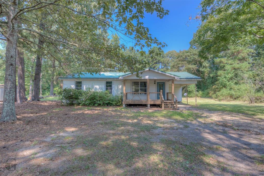 **AGENTS PLEASE READ PRIVATE REMARKS** Discover the perfect blend of comfort, convenience, and country living with this 3-bedroom, 2-bathroom home situated on a spacious 1-acre lot. Thoughtfully updated just a few years ago, this home is truly move-in ready and ideal for first-time buyers or anyone seeking peace, privacy, and room to grow. Step inside to a smartly designed layout featuring a cozy living area, a modern kitchen with ample cabinetry, and generous storage throughout. The open, airy feel makes everyday living and entertaining a breeze. Enjoy the benefits of a private well and septic system—offering both self-sufficiency and lower utility costs. Outside, the large front yard provides endless possibilities: whether you're looking to garden, raise chickens, keep a horse, or simply enjoy the wide-open space with your favorite pets. Unwind on the covered front porch as you take in the peaceful surroundings of your own slice of countryside. Located just 10 minutes from Haughton High School and with quick access to the interstate, this home offers a rural lifestyle without sacrificing convenience. Bonus: This property qualifies for Rural Development $0 MONEY DOWN financing—making it an affordable path to homeownership! Don’t miss out on this incredible opportunity. Schedule your private showing today and experience country living at its best!