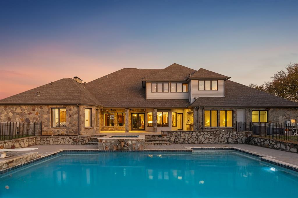 Premier Private Sherman Estate. $120K+ in updates, 2025. Luxury estate living and thoughtful craftsmanship come together at 362 Woodland Hills, a private cul-de-sac retreat set on 5+ acres inside the exclusive gated Woodland Hills community, offering an extraordinary blend of scale, privacy, and refined updates. The home welcomes you with a dramatic great room featuring a two story stone fireplace, skylights, custom solid oak, a spiral staircase, Pella casement windows, and a full bar. Additional main level living includes a well appointed family room featuring herringbone stone floors and custom cabinetry, library with a rolling ladder, exercise room, formal dining, and chef’s kitchen equipped with an island, double sinks, butler's and walk in pantry, premium appliances includes a SubZero fridge, and under cabinet lights. Extensive 2025 updates include new wide plank flooring, new iron front doors, fully remodeled primary and guest ensuites, and fresh interior paint that brightens and modernizes living spaces. The primary retreat is flooded with light, patio access, large walk in closet, and a beautifully renovated ensuite. Upstairs offers an expansive game room with a mezzanine overlook, custom built ins, and three additional bedrooms with generous closets and ensuite baths. Outdoors, the property delivers a true resort experience with a 24x40 pool, 10x10 spa, outdoor kitchen, covered deck with fans, and surround sound equipped entertaining. Additional amenities include a fully lit tennis court, basketball goal, and convertible volleyball setup, a stocked lake for fishing, 36x24 metal barn with overhead doors for RV or additional 2 car covered parking, a private well, whole home water softener and filter, and a 100 tree orchard producing nuts and fruits. With endless sunsets, generous storage, updated mechanicals, newer roof, and a peaceful country setting close to everything, this estate offers rare space, character, and comfort in Sherman's top community.