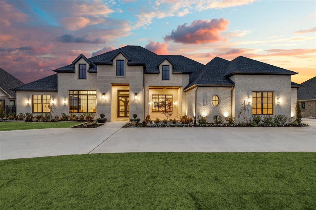 Contemporary Mediterranean–style custom home on a beautifully landscaped .73-acre lot in Argyle ISD. Offering 4,853 sq. ft. of air-conditioned living space and 7,068 sq. ft. under roof.

Designed for everyday living and grand entertaining, featuring 4 bedrooms with private ensuite baths, a powder bath, study, spacious living area, and game room with a 16’ sliding glass door opening to the outdoor living space. Interior highlights include 5” plank hand-scraped hardwood floors, solid core 8’ doors, hand-troweled textured walls, Pella windows, and Sherwin Williams Emerald interior paint.

The gourmet kitchen showcases 12’ ceilings with distressed beams, a large island, custom white oak cabinetry, and real quartzite countertops with full-height backsplash. Premium Monogram appliances include a 48” gas range with griddle, double ovens, paneled column refrigerator and freezer, two paneled dishwashers, microwave drawer, and beverage & wine cooler. The working pantry offers an additional oven, fridge & freezer, workspace, and access to the patio grill.

The primary suite features a vaulted ceiling with beams and a spa-inspired bath with freestanding soaking tub, double white oak vanities, curb-less walk-in shower with dual and rain heads, bench seating, and tile to the ceiling. The custom closet includes built ins, island, off-season hanging, and direct access to the laundry room. All secondary bedrooms offer private baths, frameless glass showers, and walk-in closets.

Outdoor living includes a 41’ x 15’ covered patio, ceiling fans, and a built-in grill area with Coyote grill and beverage refrigerator. Additional features include a circle driveway, stone and brick elevation, custom landscaping, decorative lighting, wrought iron fencing, oversized 3-car garage with epoxy floors, foam encapsulation insulation, 3-zone 16 SEER HVAC, and dual 50-gallon water heaters with recirculating pump.

Located in Denton County, City of Denton, with an Argyle mailing address.