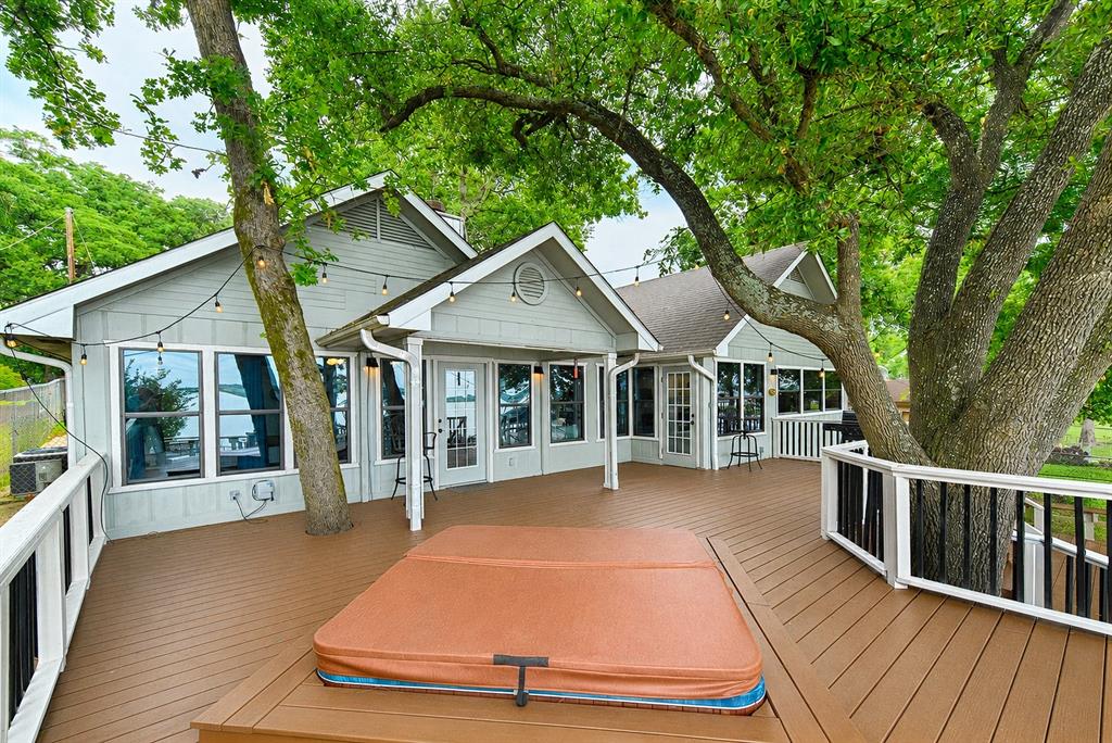Commanding big water views anchor this refined lakefront retreat on Cedar Creek Lake. A premium covered dock with boat lift and PWC lift provides entertaining space and effortless access to open water. Inside, a grand open concept living space is designed for elevated entertaining for a large family or groups. Five beautifully appointed bedrooms include an impressive 8 bed bunk suite crafted for hosting in style. Double dishwashers and dual laundry rooms enhance convenience. An expansive lakeside deck captures sweeping panoramic views, creating a true resort level setting. Property has operated as a successful Airbnb, and all furnishings are negotiable, offering a turnkey luxury experience.