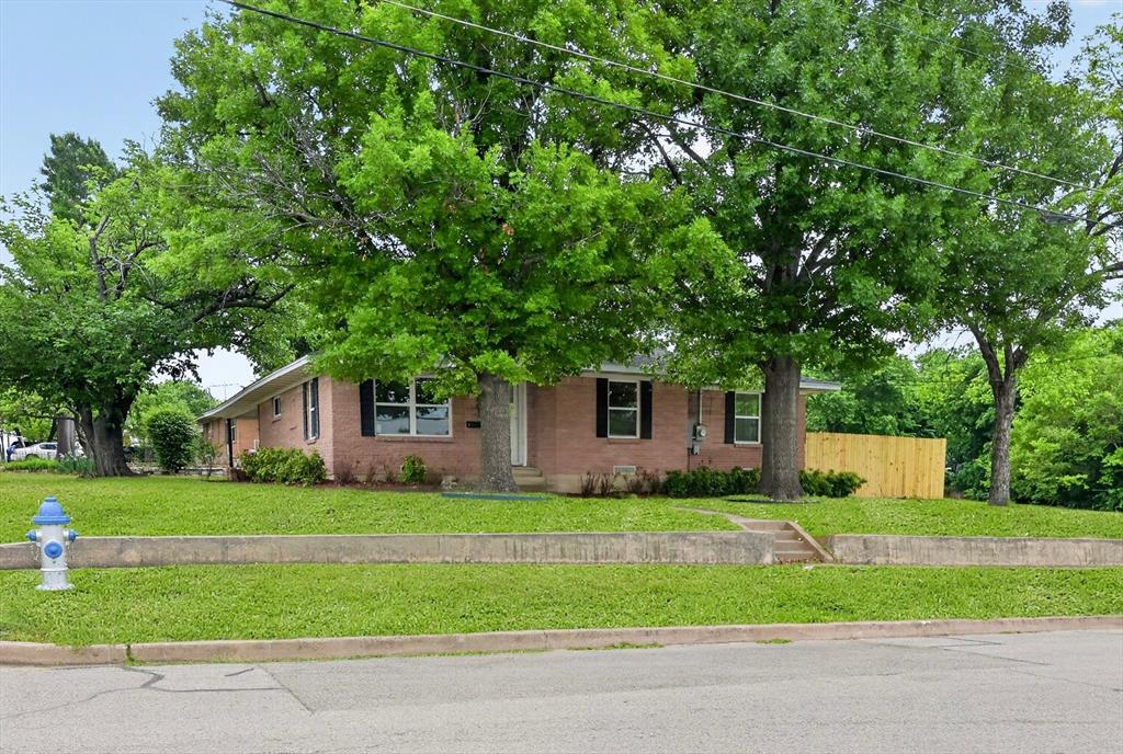 Don't miss 801 S Tennessee Street - only three blocks from Historic Downtown McKinney sitting on a charming corner lot. The beautifully updated brick home is move-in ready with all-new flooring, new paint, a fully renovated kitchen featuring quartz countertops, tile backsplash, stainless steel appliances, and a stunning primary suite with a custom walk-in shower. Additional upgrades include brand-new tankless water heater and new windows throughout. Step outside to a private yard enclosed by a new picket fence - perfect for kids and pets - plus attached two-car covered parking with extra storage.  Located within walking distance of restaurants, coffee shops, farmers markets, and year round events, you will love the home and the rare location!