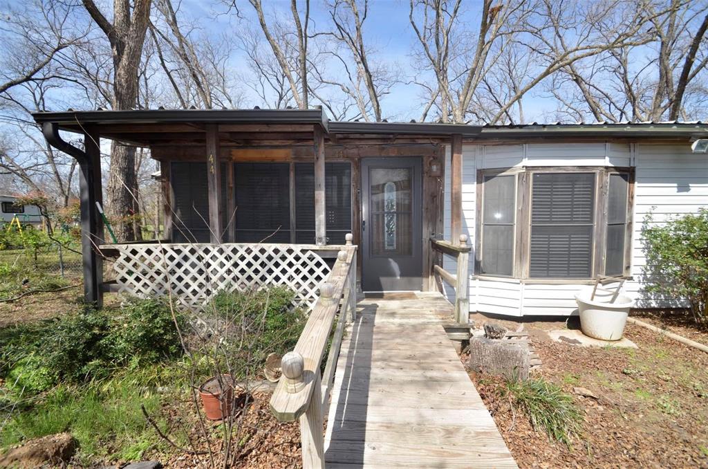 Affordable lake home or full time residence.... two bedrooms, two baths, plus two car carport and circle asphalt drive....plenty of room to park your boat or RV....floors unlevel thru part of the home... nice attached screened porch off the master bedroom.....private water well ...on site septic... storage barn (with fenced storage yard) needs roof replacement....appears a tree limb fell on it.... some time in the past....Property is less than a mile to Lake Texoma and fishing from the bank.....Selling to settle the estate.... needs some clean up and yard work... Really good level homesite for a possible future retirement home.......Call today....
