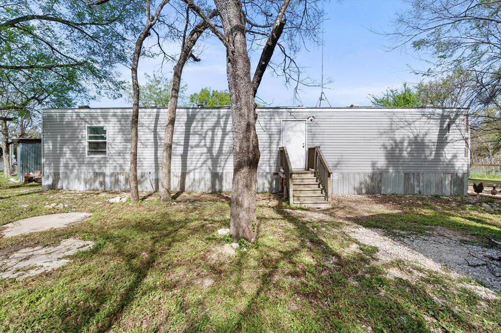 Enjoy the perfect blend of space and functionality on this 3.96-acre property! This 2-bedroom, 2-bathroom home features an enclosed porch, ideal for relaxing year-round, plus an additional enclosed area that can be used as a workshop or hobby space. The gated entrance offers privacy and security, while the fenced yard provides a great space for pets, outdoor activities, or gardening. With plenty of room to expand or customize, this property offers endless possibilities for country living with convenience.