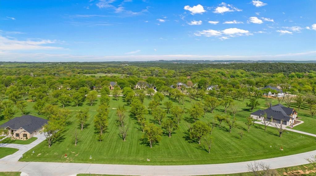 Vacant lot - come build Your Dream Home in the prestigious Pecan Plantation neighborhood, a premier master-planned community in Granbury Texas! Discover the perfect canvas for your custom home on this sprawling 1.5 acre lot nestled in the highly sought-after neighborhood of Pecan Plantation. Surrounded by majestic pecan trees and offering a tranquil setting, this expansive homesite provides the ideal blend of privacy and luxury living. Over an acre of land, ready for your new home! This part of the neighborhood is complete with concrete roads, electric service, MUD water and sewer. Orchard water and high speed internet also available. There is no timeframe in which to begin building and you can use any builder you choose. There is a minimum square foot to build of 2000 square feet. Enjoy access to two championship golf courses, pro shop, clubhouse, two private airstrips, restaurants, pools, activity center, archery range, campground, equestrian facilities, several parks, dog park, tennis courts, pickle ball, and a marina with access to Lake Granbury. The Village area features a bank, grocery store, restaurants, medical clinic, vet, golf cart shop, car wash, an Ace Hardware store and more. On-site shopping, dining, 24-7 EMS and a vibrant social scene make everyday living effortless. Minutes from the Brazos River and Lake Granbury, perfect for boating, fishing, and outdoor adventures. 24-7 gated security ensures peace of mind in this prestigious neighborhood. Come see what Pecan Plantation has to offer and build the home you have always wanted!