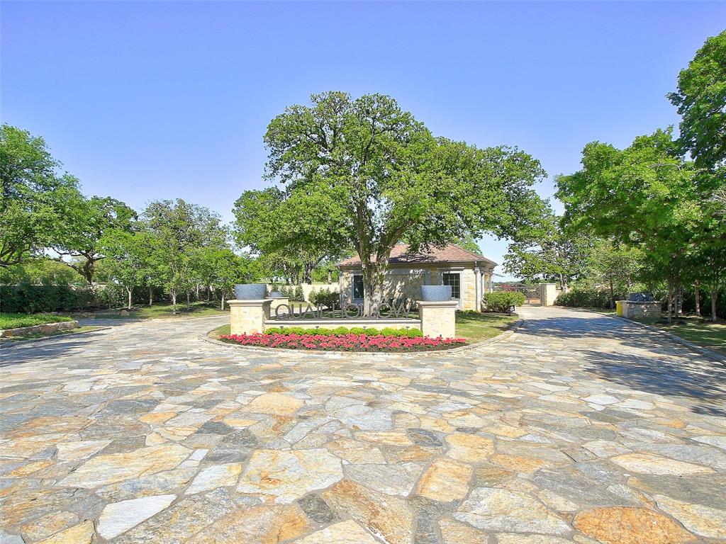 This is a Rare Opportunity to own one of the most coveted lots Nestled in the heart of the highly sought-after gated and guarded Westlake neighborhood of Quail Hollow! Create your dream lifestyle in this idyllic, prestigious enclave of DFW's most luxurious estates.  This stunning, heavily wooded interior lot spans over an acre of lush, natural beauty, towering mature trees creating a serene canopy, offering both privacy and a tranquil, park-like setting.  This corner Homesite gives you the opportunity to build facing Lakeshore Drive or Meandering Way.  Beautiful trees and sloping topography provide the starting point for your vision of this amazing 1.2 acres. The lot’s expansive size provides ample opportunity to build your dream home while still maintaining a peaceful retreat surrounded by nature. With its ideal combination of seclusion and proximity to the esteemed Westlake and Southlake communities, this property offers the perfect balance of quiet living and convenience. Zoned to Carroll ISD and Westlake Academy your students will enjoy our areas top-rated schools.   If you're seeking a rare, private oasis in one of the most desirable neighborhoods, this is the perfect canvas for your next chapter!