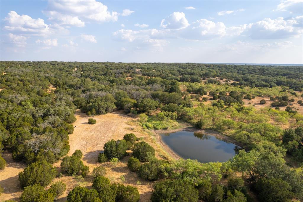 When you step onto Deep Valley Ranch, you’ll immediately sense its rare, private, and peaceful atmosphere. Nestled in the highly sought-after North-Western Mills County, this remarkable property encompasses approximately 256 acres of fertile land. It features rolling Hill Country terrain, surface water elements, and multiple potential secluded homesites. For those seeking a versatile ranch investment ready for hunting season in the thriving heart of Central Texas, Deep Valley Ranch checks all the right boxes. Water features are a standout aspect of the ranch, with seasonal tributaries winding through the property and a substantial pond that retains water even during the driest summer months. The property includes a designated homesite with a new, well-appointed hunting cabin featuring a covered porch. The cabin is equipped with air conditioning, a full bath, a water filtration system, and an instant hot water heater. Additionally, there is an RV hookup at the homesite.
