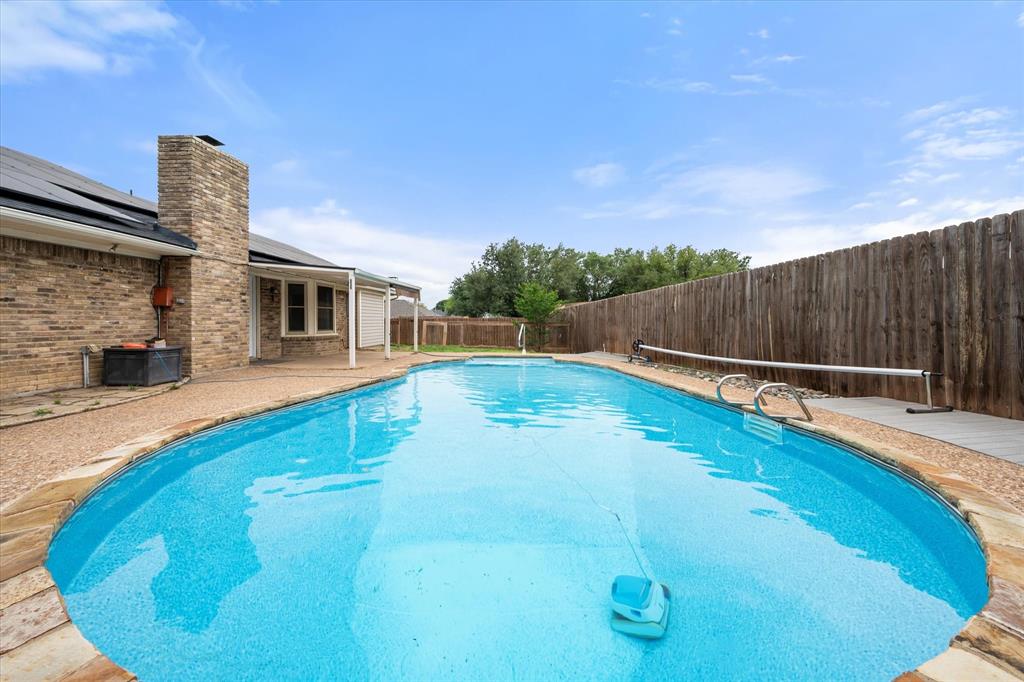 Summer-ready & move-in perfect! This updated 3BD,2BA Benbrook gem offers 1,743 sqft of stylish living with tile wood like floors, high ceilings and cleaned carpets throughout. The white-on-white kitchen shines with stainless appliances, double oven, and a charming window seat with storage. Both baths updated. Step outside to your private liner pool, ideal for the Texas heat, plus a covered patio for shaded entertaining and a separate dog run. Low maintenance front landscaping. Walking distance to the middle and high school. Keep your energy rates low, with solar panels.  HUGE BONUS: Assumable loan at under 4% interest, a rare opportunity to secure a below market rate! Solar panels are an assumable loan.