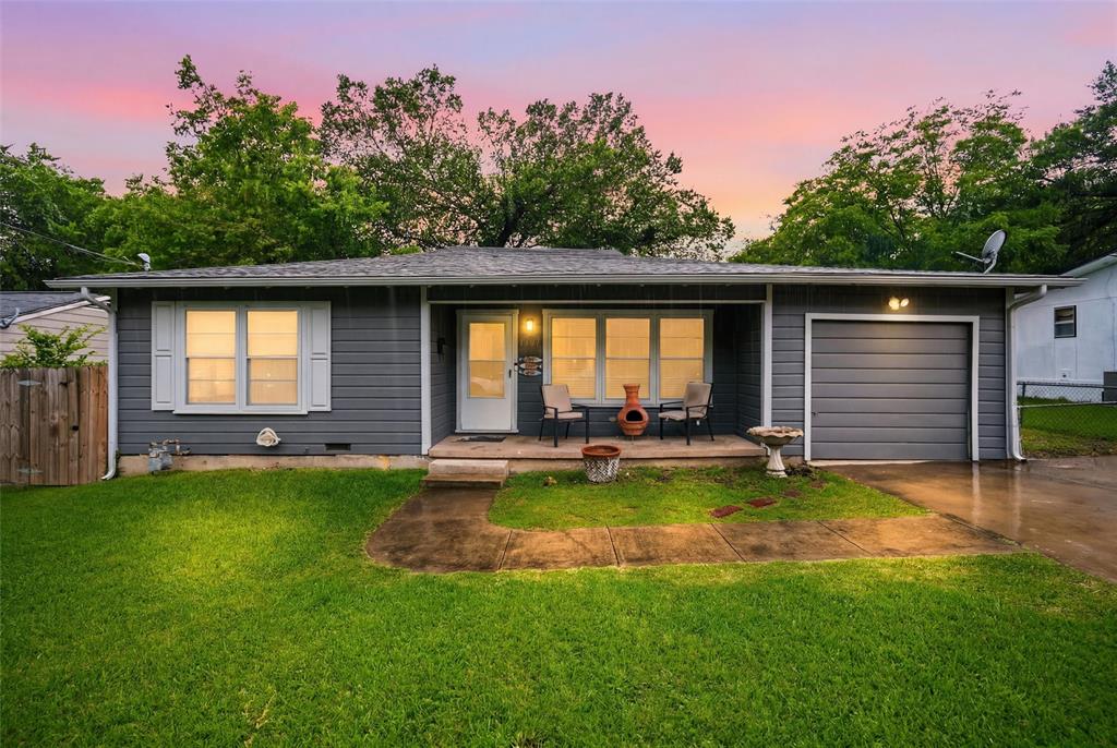 Located in downtown Ennis, this 3-bedroom, 1-bathroom home sits on a spacious lot with a large backyard ideal for kids and outdoor activities. Mature shade trees and wood privacy fencing enclose the yard, providing a comfortable and private outdoor space.The home was fully renovated down to the studs approximately 21 years ago by the original owner. Improvements included new insulation added within the wall cavities, complete rewiring of the electrical system, and replacement of the original clay and cast iron sewer lines with new lines running out to the city connection. The attic was properly insulated at the time of renovation, and a water line was added to the refrigerator area to accommodate modern appliances with ice makers. Major systems have all been recently updated. The HVAC system was replaced in 2022 and includes all new ductwork and return lines. The roof and water heater have both been replaced within the last 3 years. Inside, the home features crown molding and ceiling fans throughout. Hardwood flooring extends through the main living areas and all three bedrooms, with tile flooring in the kitchen and bathroom. The spacious living room connects openly to the eat-in kitchen. The kitchen includes white raised-panel cabinetry, tile countertops, a diagonal tile backsplash, stainless steel electric range, dishwasher, and a double sink beneath a rear-facing window. The primary bedroom includes double closet doors, and both secondary bedrooms feature double windows providing natural light. The full bathroom includes a tub and shower combination with chrome fixtures.
The covered front porch, single-car attached garage, and concrete driveway complete the exterior. For a home of this age, it is move-in ready. No HOA. Ennis ISD. City water, city sewer, and natural gas available.