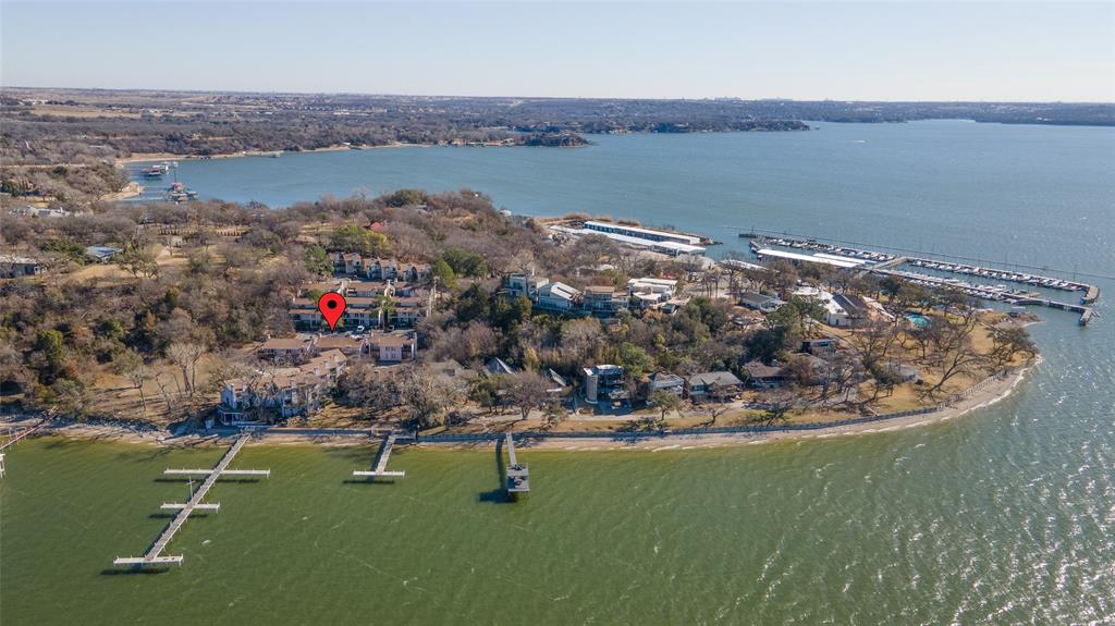 Perfect for investors!  Make an offer! Chart House Condo Community is located just outside the newly renovated FW Boat Club gate. The Chart House is a gated community itself with community boat docks and picnic tables. Perfect for those that want that lake life either full time or on weekends. The condo has two downstairs bedrooms, one with hot tub attached, each have ensuite baths. The kitchen with granite counter tops and tumbled marble back splash is upstairs and opens to a large living room with fireplace and balcony with water views. Great for entertaining. Construction is well under way!  New exterior siding, new decks, new balconies and a new metal roof are just some of the improvements for this unit and the entire complex. Currently leased and on month to month. Open water, right next door to the FW Boat Club.
