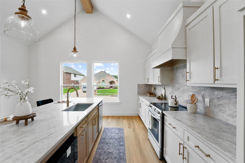 Stunning new construction on a desirable corner lot, this beautifully designed 4-bedroom, 2.5-bath home offers modern elegance and thoughtful details throughout. Step inside to an open-concept layout featuring soaring ceilings, abundant natural light, and designer finishes. The spacious living area showcases a sleek fireplace with custom built-ins, creating the perfect focal point for relaxing or entertaining.The chef’s kitchen is a true showstopper, complete with a large waterfall island, quartz countertops, custom cabinetry, stainless steel appliances, and stylish pendant lighting. A dedicated dining space flows seamlessly from the kitchen, ideal for hosting gatherings. The private primary suite offers a luxurious retreat with a spa-inspired bath and generous closet space, while the additional bedrooms provide flexibility for guests, a home office, or growing families. Situated on a corner lot, this home offers added privacy and curb appeal. Conveniently located near major highways for easy commuting to Dallas and Fort Worth. Enjoy nearby attractions including Joe Pool Lake, Lynn Creek Park, Tails ‘N Trails Dog Park, and The Parks Mall at Arlington for shopping, dining, and entertainment. Move-in ready and built with quality and style—this home is a must-see. OPEN HOUSE: Sat & SUN 12-3pm