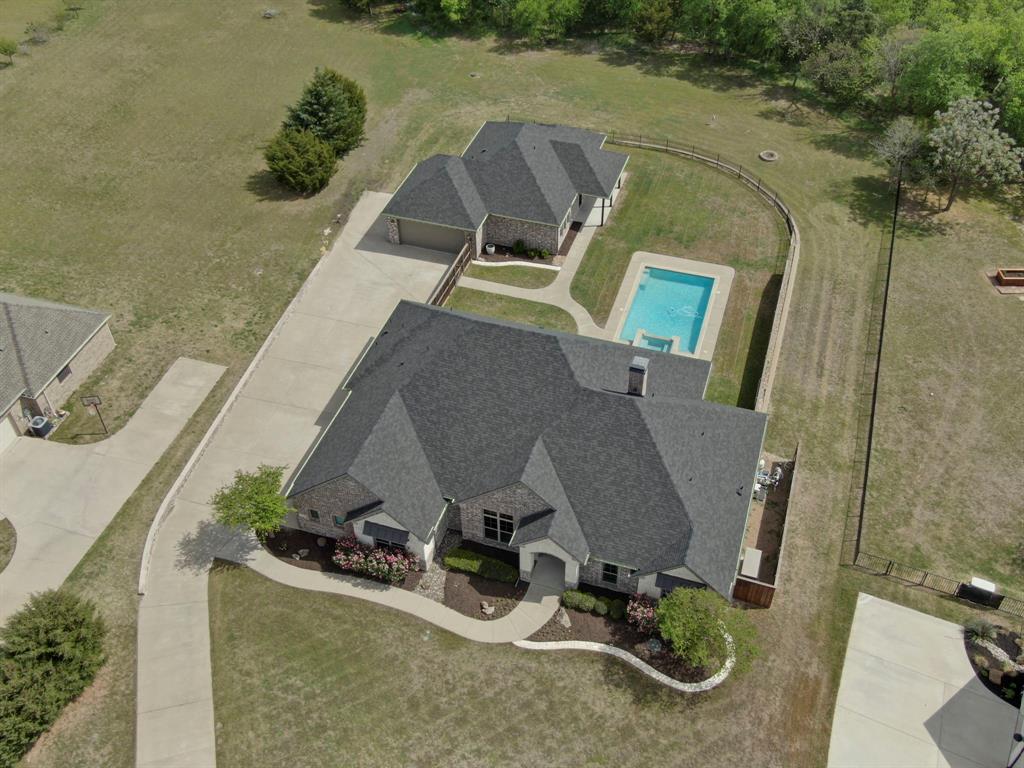 Guest quarters that live like a second home? Yes please! A casita like this is hard to come by and even harder to live without once you have them. Tucked inside Hidden Hills, one of Ellis County’s most sought after gated communities, 136 Sullivan delivers space, flexibility, and outdoor living that truly sets it apart. Freshly painted with brand new carpet, the main home offers 4 bedrooms and 3 bathrooms with a layout that flows effortlessly from everyday living to entertaining. The living room is anchored by a warm brick fireplace, while the study features built in bookcases that make working from home feel anything but ordinary. In the kitchen, a large island with a handsome dark stain steals the show, paired with a 130 bottle wine fridge that is ready for your best bottles. The primary suite is a retreat of its own with coffered ceilings, and the ensuite bath checks every box with separate vanities, a garden tub, and a walk in shower. The main home also includes a 3 car garage for plenty of storage and function, and a generator to power your necessities in bad weather!
The casita truly lives like its own residence. Complete with a full kitchen, dining area, oversized living room, and a convenient half bath for guests, it offers incredible flexibility for long term stays, multigenerational living, or even a private office setup. The guest suite includes its own bathroom with a walk in shower, creating a comfortable and private retreat. And the 2 car garage opens the door for even more possibilities think workshop, gym, extra storage, or a place for all the toys.
Outside, the pool and hot tub sit perfectly between the main home and the casita, creating a private backyard setting that feels like your own personal getaway just in time for Texas summers.
Opportunities like this do not come around often!