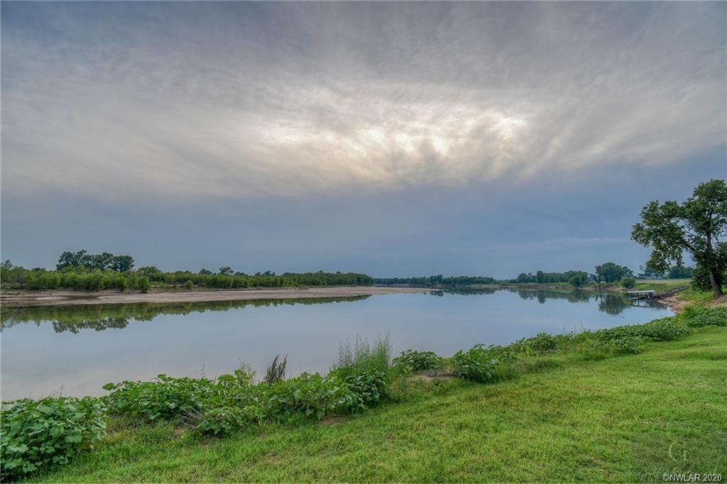 Experience the luxury of owning an expansive, prime waterfront lot that boasts enchanting views of the brilliant hues of the sunset, nestled within the esteemed River Bluff Subdivision. This exquisite property finds its home on the verdant banks of the iconic Red River, offering you an unmatched opportunity to build your dream residence surrounded by pure tranquility and natural beauty.
The lot itself is pleasingly level, providing the perfect blank canvas to create a home that reflects your unique style and taste. Embrace the potential for exquisite landscaping and outdoor design, or simply savor the natural charm of your surroundings - the possibilities are truly limitless.
The seller, directly motivated by the desire to pass on the reins to someone who can appreciate its true potential, has invested an impressive amount into developing this property.