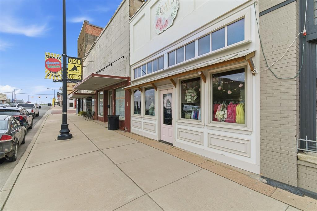 Located in the heart of Downtown Cisco on highly visible Conrad Hilton Boulevard, this charming two-story commercial property offers a rare opportunity to own a piece of local history in a prime retail location. Currently operating as a successful clothing boutique, the space is full of character and thoughtfully designed, making it ideal for a variety of retail or business concepts. The main level features an inviting storefront with excellent visibility and natural light—perfect for showcasing inventory and attracting foot traffic. Inside, you’ll find a well-laid-out retail 
floor, a dedicated fitting room, and a spacious back stock area that provides ample room for storage and inventory management.Upstairs, a loft-style second level offers flexible space that can easily function as additional retail, office space, creative workspace, or storage—adding both charm and versatility to the property. With over 2,200 square feet, established business potential, and a prime location along one of Cisco’s most traveled areas, this property is perfectly positioned for entrepreneurs ready to bring their vision to life. Whether continuing as a boutique or introducing a new concept, this is a standout opportunity in the heart of Downtown Cisco.