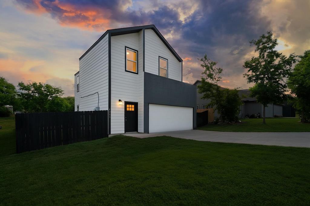 Your next chapter starts in Granbury — and this two-story home in established Lakeside Hills is ready to make it easy. Step inside to soaring ceilings and an open-concept layout that immediately feels bigger than the square footage suggests. Natural light moves freely from the kitchen through the living area, making this the kind of space that works just as well for a quiet Tuesday night as it does for a weekend full of people. The kitchen anchors it all with granite countertops, stainless steel appliances, recessed lighting, and a layout designed to keep the cook in the conversation. 
The primary bedroom is on the first floor, a genuine advantage for everyday living with a private ensuite that keeps the main level self-contained. Upstairs, two additional bedrooms and a full bath flex easily for guests, a home office, or whatever this season of life calls for. The attached two-car garage is a standout feature in this price range, delivering covered parking, real storage capacity, and the kind of everyday convenience that buyers don't fully appreciate until they don't have it. Pull in, unload, and be home. Out back, an oversized fenced yard gives you room to breathe, garden, or just let the evening happen at its own pace. All of this sits minutes from Granbury's historic downtown square, Lake Granbury, and the shops, dining, and recreation that make this community worth planting roots in.