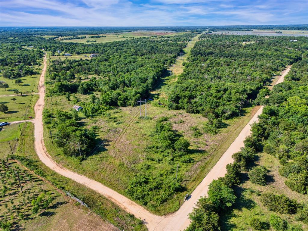 This wooded 11.12-acre tract offers a peaceful slice of country living just outside the city limits. The property features mature trees throughout, a small tank, and a seasonal creek that adds natural character and privacy. Located on the corner of LCR 462 and LCR 5460 in the Mexia ISD, the land provides several ideal building sites—whether you’re looking for a tucked-away homesite among the trees or a more open setting. A shed is already on the property, and a possible water tap may be available (buyer to verify). Quiet, rural, and full of potential—this is a solid piece of land ready for your vision.