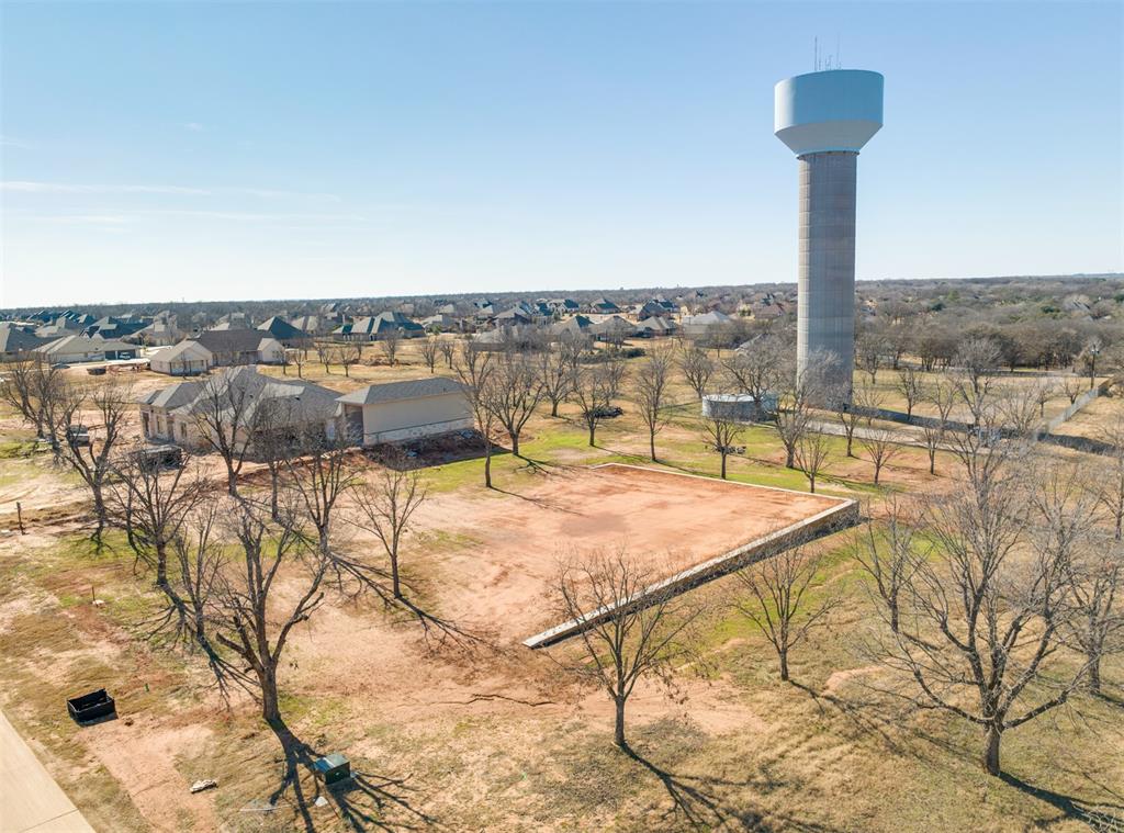 GORGEOUS, SITE-READY LOT IN NEW ADDITION IN PECAN PLANTATION. This lot is a little over an acre with a 10,000 SF pad immediately ready for building your dream home. Level. Lots of good top soil. Extensive rock retaining walls already installed and done right. Sturdy, solid concrete footings. Tops of retaining walls have holes and sleeves ready for installing an iron fence. A number of mature pecan trees on the property. Beautiful views of the orchard in an area where larger homes are being built. Close to the Pecan Business Village, with grocery store, medical clinic, pharmacy, bank, veterinarian, golf cart shop, beauty shop, car wash, new Ace Hardware, and more. Just down the street from the Pecan Activity Center and dog park. Pecan Plantation is a gated golfing community surrounded by the Brazos River. Subdivision has its own top-notch VFD and a 24-7 EMS with CareFlite inside its gates. Two airstrips, clubhouse & marina. Minutes from Granbury and an hour from Ft. Worth.