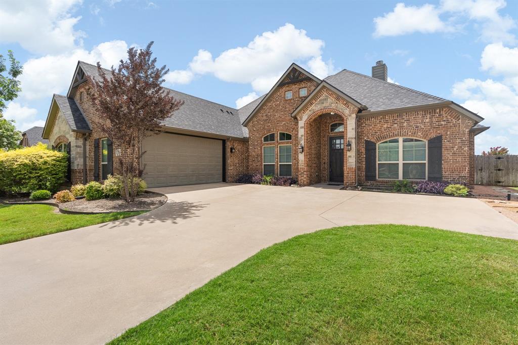 This home makes a striking first impression with its timeless brick-and-stone exterior, manicured landscaping, and inviting architectural details. A wide driveway leads to the J-swing garage, allowing the elegant front elevation to take center stage. The arched covered entry creates a warm welcome, while decorative shutters, varied rooflines, and stone accents add character and curb appeal. Mature trees and lush green lawn frame the property, providing both beauty and shade. Thoughtfully designed landscape beds with ornamental shrubs and colorful plantings enhance the home’s polished appearance. The combination of rich brickwork, attractive rooflines, and well-maintained grounds creates a classic yet upscale presence that stands out in the highly sought neighborhood with NO HOA and quick access to HWY 287. Enter to  open-concept living design, stone accents on island, granite counter tops and beautiful cabinetry.  Large dining area opens to living with stone fireplace & tall windows for natural light. Hand-scrapped wood floors, office with closet can be 4th BR. This open floor plan designed for family comfort or entertaining. Gorgeous stone fireplace! Large master suite with beautiful tile work in walk in shower, separate soaking tub and large walk in closet. Back yard has a unique dog run with access to inside plus a large grass area with trees, nice landscaping and plenty room for children to play, adult entertaining or to add a pool.  Huge walk-in pantry, back-pack zone with bench and storage.  This one will fit all your needs.