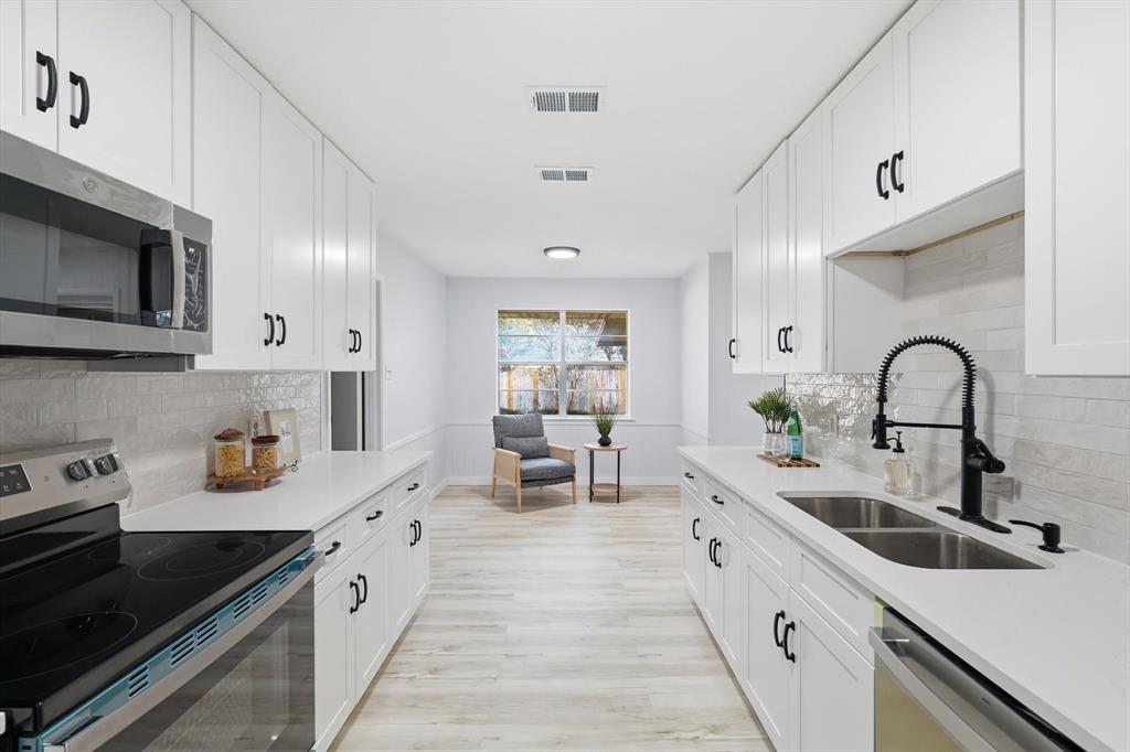 Tucked beneath mature trees on an oversized lot in the heart of Wedgewood, this fully updated home blends timeless character with modern design. Every major living space has been thoughtfully refreshed, creating a move-in-ready home that feels bright, clean, and effortlessly stylish.

Step inside to light oak luxury vinyl plank flooring, fresh designer paint, recessed lighting, and a dramatic black brick fireplace that anchors the living room with warmth and personality. Large windows fill the home with natural light, giving every room an open, inviting feel.

The beautifully remodeled kitchen features quartz countertops, crisp white cabinetry, a classic subway tile backsplash, matte black hardware, brand-new stainless steel appliances, and an efficient layout that offers generous storage and workspace without sacrificing style.

The primary suite provides a private retreat with an updated ensuite bath complete with a spacious walk-in shower, modern tile surround, sleek black fixtures, and a dedicated vanity. The secondary bathrooms have been updated with matching quartz countertops, contemporary lighting, and cohesive finishes throughout the home.

Outside, the covered patio overlooks a backyard that's larger than many you'll find in the neighborhood, offering plenty of room for entertaining, gardening, pets, or future additions.

Located in one of Fort Worth's most established neighborhoods, you'll enjoy mature trees, generous lot sizes, nearby parks, shopping, restaurants, and convenient access to I-20 and I-35W.

Completely updated, move-in ready, and eligible for FHA financing, this is the kind of home buyers have been waiting for.