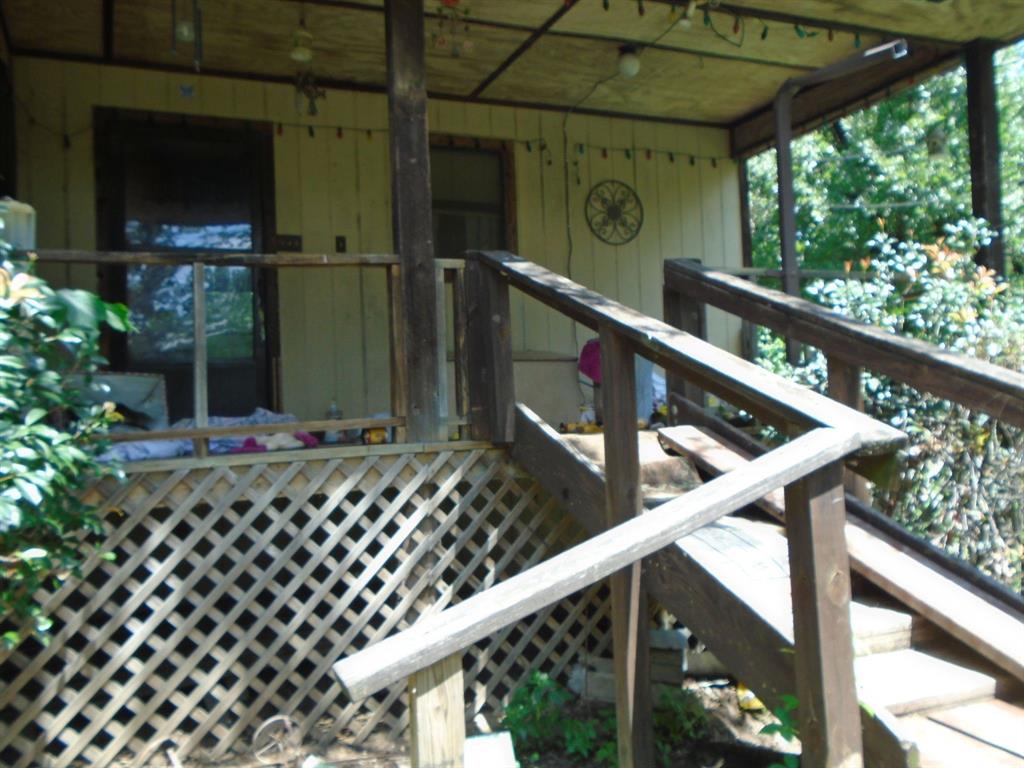 Small house approximately 1008 square feet 2 Bedroom 1 Bath with carport and outbuilding on 1.07 acre property with beautiful mature Oak trees.
Located in a quiet area of the country but still close enough to just about everything. Discover the potential of this 1.07 acre property located outside city limits offering privacy, space, and versatility. While the interior of the home is ready for updates, this property presents a great opportunity to customize and add value in a peaceful country setting with room to grow. !!! Bring your paint brush and hammer as this home is in need of TLC and updating. This could make a great retirement home or rental property just bring your imagination.  There is an ingress-egress easement through which is currently being used as a driveway.The seller does not accept blind offers or escalation clauses. Buyer or buyer’s agent to verify all property details, exemptions, and measurements verifying all information. Buyer will need to purchase survey. Schedule your visit today. BRING ALL OFFERS!