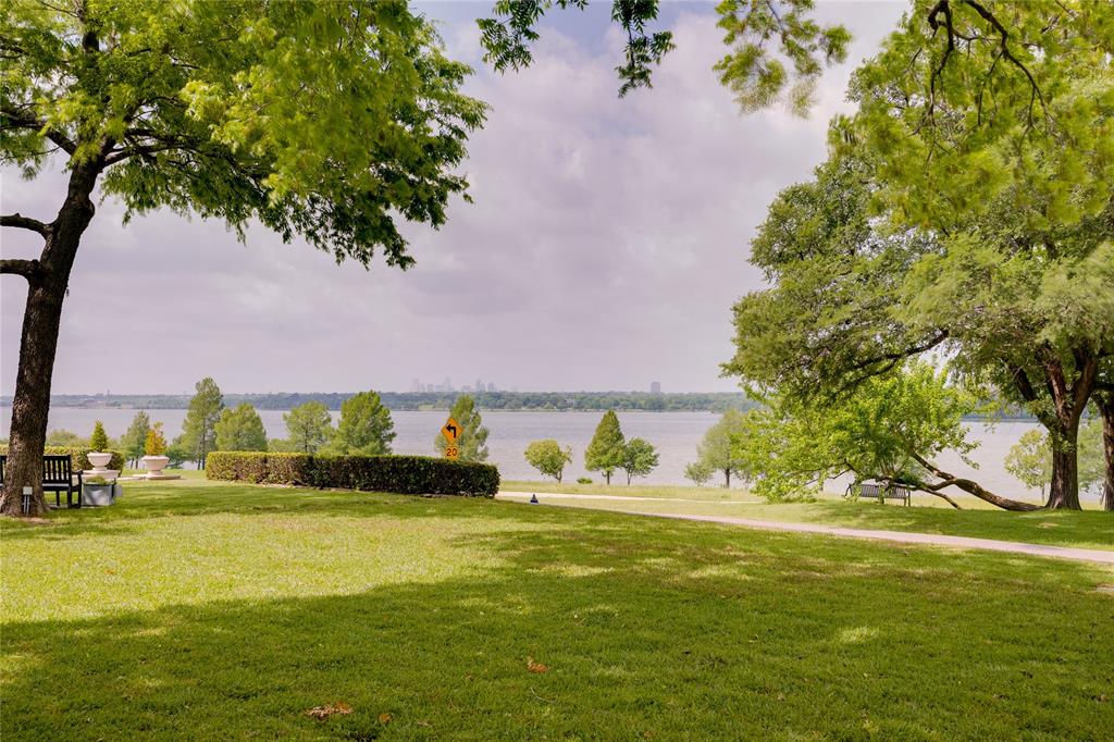 9210 W Lake Highlands Drive is an extraordinary retreat, privately positioned to capture unobstructed panoramic views of Downtown Dallas and the full expanse of White Rock Lake. With 5 bedrooms, 4 baths, this beautifully designed residence blends sophisticated interiors with an unforgettable natural setting.

Created for elevated everyday living and exceptional entertaining, the home is defined by its seamless connection to the outdoors. Walls of sliding glass doors open completely, inviting the lake in and revealing breathtaking water and skyline views at every turn. At the heart of the home, the open gourmet kitchen is both refined and functional, designed for gathering with ease while remaining connected to the home’s stunning living spaces and vistas beyond.

An oversized indoor fireplace anchors the main living area with warmth and architectural presence, while an outdoor fireplace extends the experience to the home’s generous porches and terraces, creating inviting spaces for year-round entertaining. From morning coffee overlooking the lake to evenings spent by the fire with the downtown skyline shimmering in the distance, every detail is designed to celebrate the setting.

Crowning the home is a rooftop deck that offers a spectacular perch for watching sailboats glide across White Rock Lake, city lights sparkle at dusk, and stars fill the night sky. Rarely does a property offer this level of beauty, privacy, and lifestyle in such a premier Dallas location.

9210 W Lake Highlands Drive is more than a home—it is a statement property, offering timeless design, remarkable views, and a truly elevated way of living.