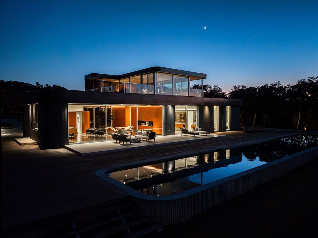 One of the finest examples of modern architecture combined with an equestrian lifestyle. The residence sits on the highest point on the property. After walking through the threshold, you will notice a grand view through the living areas of the house, overlooking the back deck, koi ponds, and 80 ft long salt water swimming pool, across the pasture to the equestrian facilities. Luxurious open concept living space, and the kitchen is ideal for the master chef with Gagneau appliances and a full butler’s pantry. Going up the stairs to the second floor viewing with wet bar. The lower level features an acoustically balanced theater complete with a 250-bottle wine cooler, 8 ft concert walls, and a powder bath. The barn has six stalls and one foaling stall, with individual turnouts. Attached to the barn is a fully covered riding arena turnout for grazing and a round pen for training. The property backs up to Corp of engineers property that surrounds Lake Grapevine.