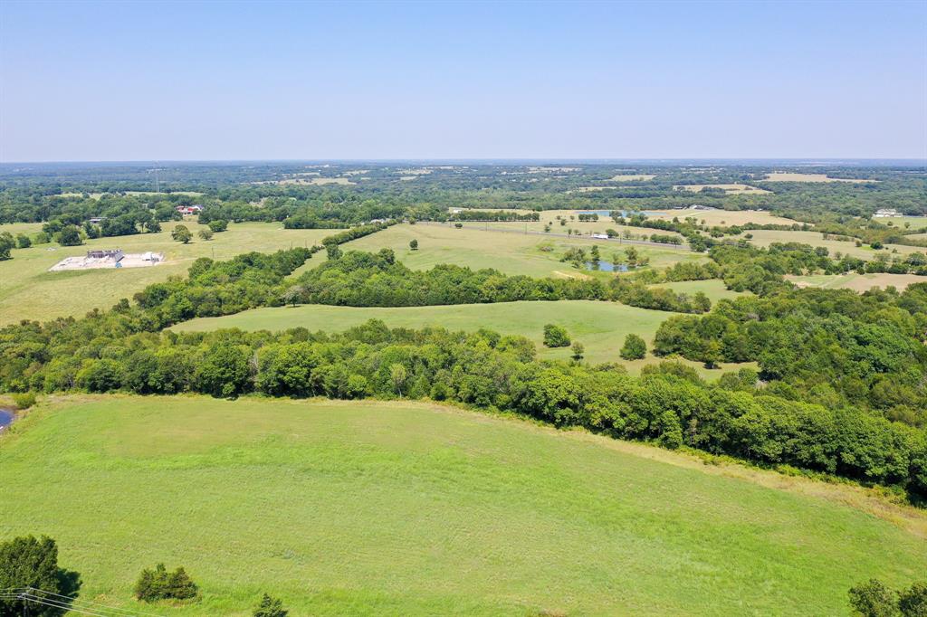This gorgeous 58.82 acre property, just minutes from Sherman, is a fantastic opportunity for development or investment.  It has approximately 822 feet of frontage on US Hwy 82 AND 1,362 feet of frontage on US Hwy 69!  This area of North Texas is booming with growth with industry leaders such as TI, GlobiTech, Coherent, Emerson, Tyson, Texoma Medical Center, Grayson College, Kaiser Aluminum, and many others.  It is fully fenced and currently used for cattle with a large pond and a corral, which adjoins the neighbor’s cattle chutes.  There is a beautiful mixture of improved pasture and heavily treed, rolling terrain.  There is a small cemetery on the east border of the property and some flood plain near Mill Creek.  Check out the drone video or schedule a visit to see this phenomenal location yourself!