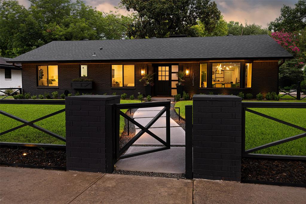Fully reimagined modern home in Eastwood, zoned to Hexter Elem. Transformed with high-end, top-to-bottom renovation. Every surface refined, featuring smooth Level 5 museum-finish walls + ceilings, premium 8-inch baseboards, modern window trim & custom laser-cut air vent covers. Interior showcases a sophisticated, high-contrast aesthetic, highlighted by a white brick dining accent wall and dramatic fireplace fitted with modern stone spheres. Modern Upgrades & Features: Chef’s Kitchen features a waterfall island, sleek charcoal cabinetry, polished chrome hardware, and marble backsplash. Designer Finishes: New shaker interior doors, many w frosted glass, guest half-bath w stunning designer tile & premium wall coverings, and spacious primary suite with spa-inspired bath. Smart Home Integration: Fully connected including WiFi-enabled smart dimmer & canned lights, smart thermostat, exterior lighting, and electric roller shades—all controlled via smartphone or Alexa. Ultimate Outdoor Experience: Exterior completely re-landscaped for maximum curb appeal + privacy. Front entry defined by unique, custom-designed modern fence, featuring low-voltage ground lighting surrounding the property and dramatic soffit-mounted strip lighting that illuminates the entire home at night. Walkway is elegantly outlined by gravel and path lighting, complemented by boxwoods. The private backyard is a seamless extension of the living space, featuring high-end black concrete and lush turf, perfectly set up for entertaining w integrated landscape lighting. The standout is the fully climate-controlled, 571sf attached garage. Finished w epoxy flooring, custom built-ins + integrated TV, this space is an extension of the home w limitless potential as a workshop, studio, or gym. Covered carport for additional parking. New, dedicated laundry room with built-in W-D. Meticulously maintained & move-in ready, this home blends contemporary luxury w high-tech convenience in a prime East Dallas location.