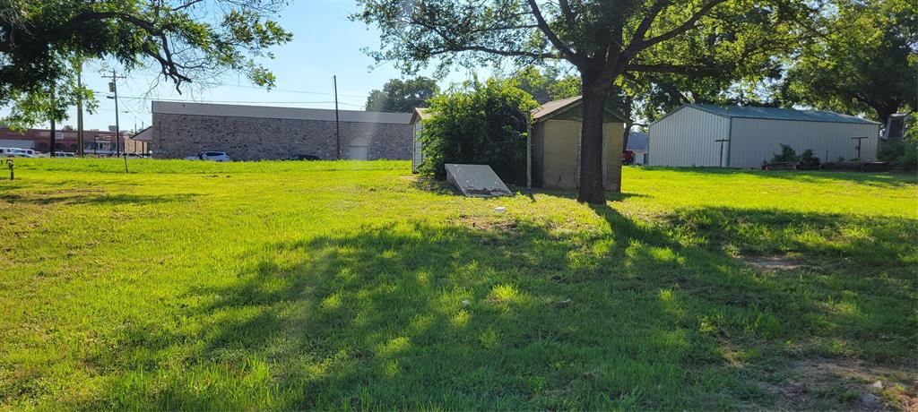 Corrner lot currently zoned residential but could possibly be rezoned for commercial, this could be a great location for a business. 
This lot boasts high traffic exposure potential being near to  local shops, restaurants, and community amenities. This lot has a water well and cellar, both are in unknown condition, the storage building conveys with the property.