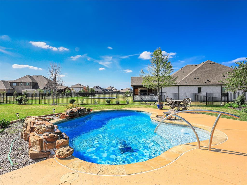 Beautiful custom home in the Golf Course community of Bridges at Preston Crossing in Gunter, TX. This spacious 2,968 sq. ft. residence sits on a corner lot and offers a blend of functionality and comfort, featuring three bedrooms plus a dedicated office-flex room that can easily serve as a fourth bedroom or guest space. Inside, you’ll find luxury features such as the island dresser in the master closet, crown molding, hardwood floors, an open-concept layout, and a welcoming living area with a fireplace and built-in shelving, ideal for everyday living and entertaining. The chef’s kitchen includes modern appliances, ample cabinetry, and a large island with seating, opening to a light-filled dining area. The primary suite offers a private retreat with dual vanities, a soaking tub, and a walk-in closet. The two secondary bedrooms each feature their own en suite bathrooms, providing privacy and convenience for family or guests. Step outside to a backyard designed for Texas living, complete with a pool and space to entertain. Additional highlights include a spacious three-car garage, with epoxy floors, dedicated laundry room, and ample storage. Residents of Bridges at Preston Crossing enjoy community amenities including a golf course and tennis courts, along with a quiet, well-maintained neighborhood setting.