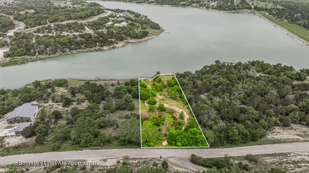 Beautiful Beacon Lake lot with great lakefront views. This one acre lot offers approximately 100 feet of water frontage. Nice hardwoods scattered throughout. Partially cleared with road. Water and electric located at the front of the lot. No build time. 295.00 yearly assessment. 1400 square foot minimum living space. Mountain Lakes offers a recreational lake, fishing lake, clubhouse, pool, park, walking path, garden and RV park. Build your dream home now or build later and enjoy the amenities. This is country living at its finest with BEAUTIFUL Texas sunsets, star filled skies and abundant wildlife. Bluff Dale is located on HWY 377 between the 'Cowboy Capital of the World', Stephenville TX and the Historical Granbury TX.