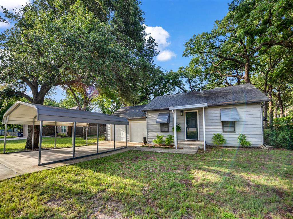 Welcome to this beautifully updated cottage-style home nestled on a spacious corner lot in the established Indian Oaks neighborhood near Lake Worth. Blending timeless charm with modern upgrades, this move-in ready home offers comfort, character, and functionality all in one. Inside, you’ll find original oak hardwood floors paired with new ceramic tile and luxury plank vinyl throughout. The flexible floorplan features 2 bedrooms, 2 full bathrooms, a cozy living area, dining room, dedicated laundry room, and an updated kitchen with abundant cabinet space. All appliances are included — washer, dryer, refrigerator, gas range, and dishwasher — making this home truly turnkey. Recent updates include central heat and air installed in January 2026, along with extensive interior improvements throughout the home. Outside, the oversized corner lot is shaded by mature oak trees and offers a private fenced backyard perfect for relaxing or entertaining. Additional features include a double carport, two large storage buildings, plus a workshop and hobby room providing exceptional storage and workspace without the need for off-site storage. Conveniently located near shopping, dining, Eagle Mountain Lake, and major highways, this property is ideal for first-time buyers, down-sizers, or anyone looking for a cozy home with modern updates and extra space to enjoy.