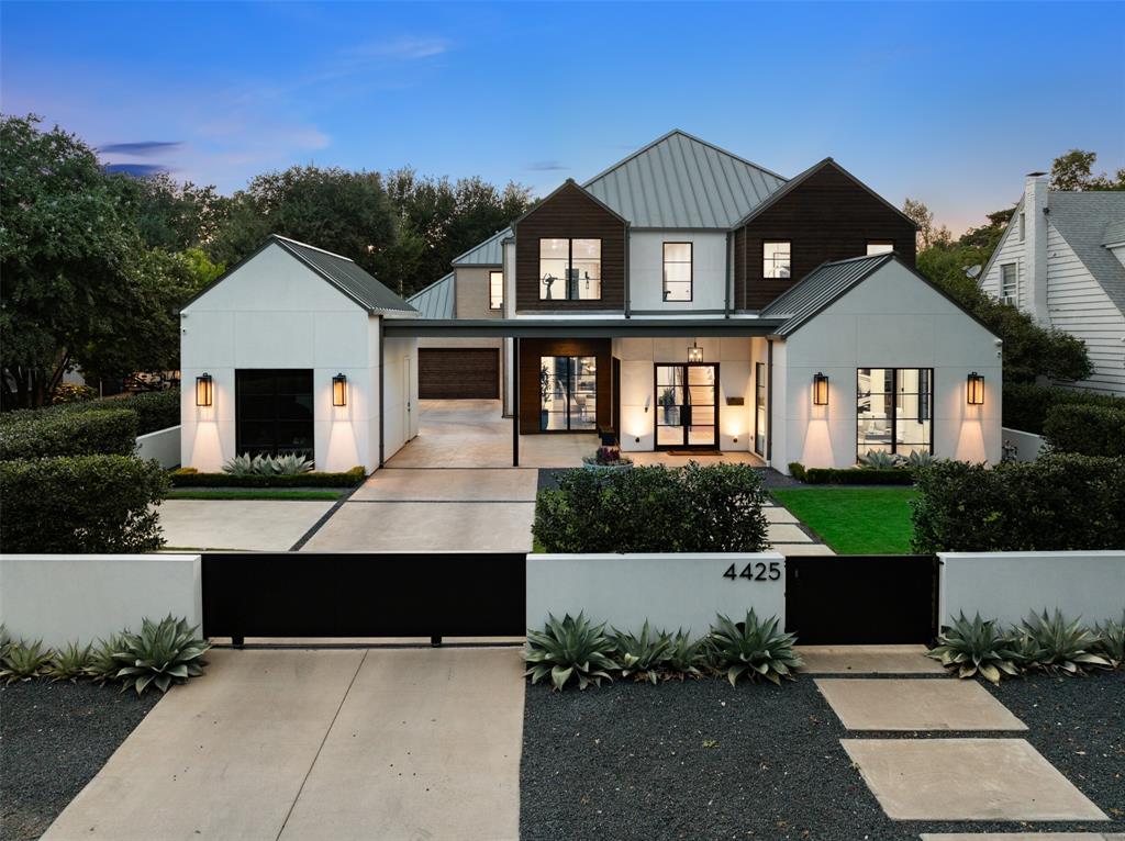 Completed in 2020, this striking modern retreat in coveted Bluffview offers a rare blend of architectural sophistication and resort-inspired living. More than $500K in curated upgrades elevate the experience, including a saltwater pool and spa, dramatic exterior lighting and a whole-home filtration system. Lush, professionally designed landscaping wraps the front, side and rear grounds, creating remarkable privacy behind walls of glass that flood the interiors with natural light.

At the heart of the home, an oversized waterfall island anchors the open-concept living and kitchen area, seamlessly connecting to a covered patio with drop-down screens for effortless indoor-outdoor entertaining. Soaring ceilings, designer lighting and a refined material palette add warmth and dimension throughout. The primary suite is a serene sanctuary with tranquil pool views, a bespoke custom closet and direct access to the oversized laundry room. A semi-formal dining space and two additional first-floor bedrooms—one currently styled as a private office—complete the main level.

Upstairs, four distinct living areas provide exceptional flexibility, currently appointed as a gym, media room, game room and screened, outdoor lounge. Three spacious bedrooms each feature walk-in closets and ensuite baths, offering comfort and privacy for family and guests alike.

The backyard is designed for both intimate evenings and lively gatherings, with covered and open-air seating areas surrounding the outdoor kitchen and shimmering pool. A walled and gated front yard enhances both security and curb appeal, completing this polished, private enclave just moments from Sudie Williams TAG Academy, premier private schools, and the boutiques and dining of Lovers Lane.