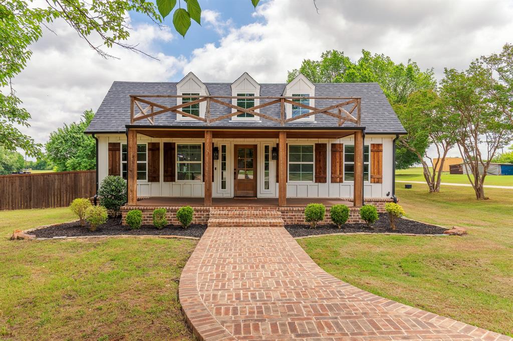 Set on a 1.69 acre, tree-filled lot, this beautifully designed home offers exceptional curb appeal with a covered front porch, circle drive, mature trees, and a privacy fence creating a peaceful retreat. Inside, rich wood floors, tall ceilings, and an open-concept floorplan create a warm and inviting atmosphere perfect for both everyday living and entertaining. The spacious family room features custom built-ins and a stunning fireplace, flowing seamlessly into the gourmet kitchen complete with a large island, stainless steel appliances, gas cooktop, butler’s pantry, and abundant storage. A generous dining room provides the ideal setting for hosting gatherings and special occasions. The oversized primary suite is a true escape, featuring dual vanities, a large soaking tub, an extra-large walk-in shower, and elegant chandelier accents. Thoughtfully designed spaces throughout include a mud room with built-in organization, a large utility room with tons of storage, and an upstairs loft with additional built-in storage. Outdoor living is just as impressive with a large back deck overlooking the expansive backyard, plus a paved firepit area and basketball hoop for endless entertaining and recreation opportunities.
