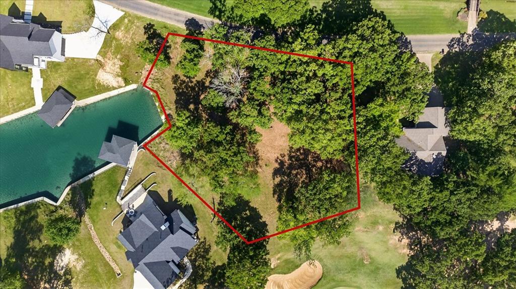 MOTIVATED SELLER! When this lot sells, it's over. There will not be another chance to build on this cove. This is the last remaining homesite along the storied Red Bridge cove at Pinnacle Golf Club, and a combination like this simply does not come available again on Cedar Creek Lake. Nearly one acre spanning two combined lakefront lots, this extraordinary property delivers a trifecta that buyers spend years searching for: private cove waterfront, direct 8th green golf course frontage, and panoramic views of the historic Red Bridge one of the most iconic and photographed landmarks on the lake. Mature trees frame the lot naturally, providing shade, privacy, and the kind of character that new developments simply cannot manufacture. Launch your boat straight from your backyard, spend the afternoon on the course steps from your door, then come home and watch the sun set behind the Red Bridge from your own porch. This is not a lifestyle you can approximate elsewhere it is specific to this cove, this view, and this last lot. As a resident of the prestigious Pinnacle Golf Club a luxury gated community you'll enjoy resort-style amenities including a newly renovated clubhouse and restaurant, Pro Shop, pool, fitness center, pickleball courts, and a vibrant social calendar. All of it just one hour from Dallas, making this the perfect full-time escape or weekend sanctuary. Lots with this combination of water, golf, history, and community don't wait. The buyers who act on properties like this are the ones who look back and say they made the best decision of their lives. The ones who wait miss out.