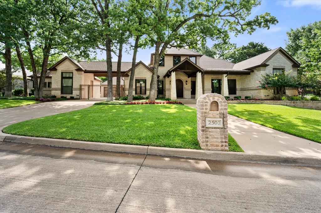 Custom-built home in the highly sought-after gated community of Estates of Creekwood, known for its beautiful trees, privacy, and spacious homesites. Situated on an oversized double lot of approximately half an acre, this 4-bedroom, 4.5-bath home offers incredible space inside and out. Fresh paint and new carpet give the home a clean, updated feel. The thoughtfully designed floor plan features oversized bedrooms, a dedicated office, and two game rooms — one downstairs and one upstairs. A private downstairs bedroom wing includes two bedrooms, each with ensuite baths, connected by a spacious game room, creating an ideal setup for kids, guests, or multi-generational living. Upstairs, the second game room offers additional flexible living space for media, hobbies, or play. The oversized garage is designed to accommodate larger vehicles, while the third-car garage functions perfectly as a large workshop, hobby space, or additional storage. Outside, enjoy the heavily treed backyard with plenty of room to entertain, relax, and gather around the large firepit. Located in Mansfield ISD with convenient access to major highways, making the commute to Fort Worth, Dallas, and surrounding cities a breeze. A rare opportunity to own a custom home on a large treed lot in one of the area’s most desirable gated neighborhoods.