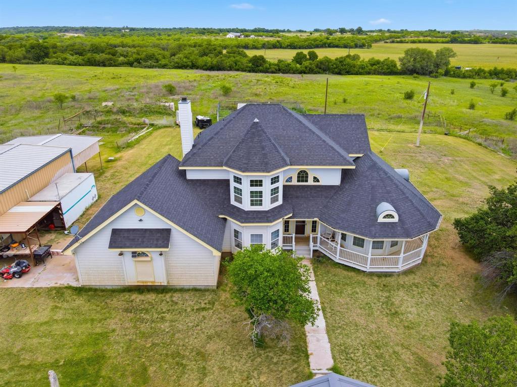 Nestled among the rolling hills, this beautiful 3 bedroom, 2 bath country retreat offers the perfect blend of privacy, functionality, and wide open Texas skies on 15 picturesque acres. Surrounded by breathtaking views and peaceful countryside, this property is ideal for those looking to enjoy rural living while still having modern conveniences.
The home features a warm and inviting layout with spacious living areas, abundant natural light, and a beautifully designed kitchen complete with custom wood cabinetry, granite countertops, and an oversized island perfect for gathering with family and friends. Cozy up by the wood burning stove while enjoying the charm and comfort this home provides.
Outside, the property is set up for both work and play with a large shop offering plenty of room for equipment, hobbies, storage, or projects. The land is fenced and ready for livestock, recreation, or simply enjoying the serenity of country life. A solar powered well system provides water for irrigation and livestock needs, while co-op water services the home. The property also includes a septic system already in place.
Whether you are searching for a homestead, horse property, weekend getaway, or peaceful place to call home, this stunning acreage offers endless possibilities and unforgettable views in every direction.