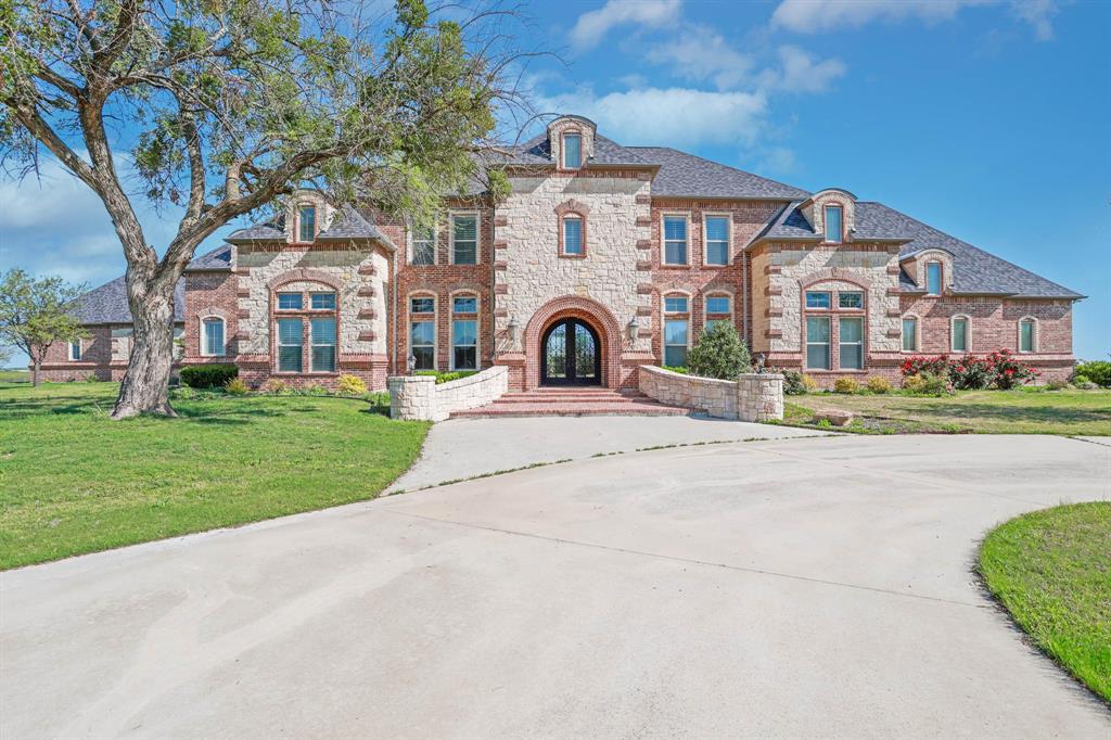 Step into luxury combined with equesterian and agricultural facilities while enjoying the beautiful picturesque views of sunsets over Lake Ray Roberts. Custom woodwork throughout the open living areas and chefs kitchen is enhansed with double sinks, dishwashers, ovens and superior ice machine. Five ensuit bedrooms, three half baths, library, multiple game rooms with functional kitchen bar and extending to outdoor decking with magnificent view. Ample storage in every corner including the soft flooring in exercise room. Enjoy the outside pool with water fall and swim up cave all while enjoying watching the horses and cattle. the barn is equiped with 12X12 stalls and turn outs, hay room, tact room office with half bath and kitchen. Parking for horse trailers and mootor homes with plug ins. 61.373 beautiful acres.
Call Jill Bridges for appointments and questions:214-704-0679