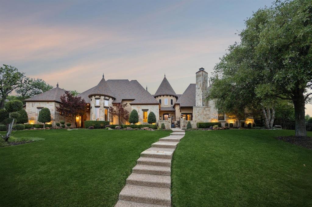 Dreams have an address — and this is it. Nestled within the prestigious Southern Hills of Keller, where nearly an acre of lush, manicured grounds sets the stage, 1216 Pine Hurst Drive welcomes you into a world of effortless luxury and timeless warmth. From the hand-forged wrought iron entry door to the soaring wood beam ceilings, every detail was chosen with intention and every room tells a story of craftsmanship, comfort, and extraordinary living. A private courtyard entry leads into an intentionally designed floor plan that flows beautifully from room to room. The chef's kitchen is anchored by an oversized island with extended seating, double ovens, a 6-burner gas cooktop, and a built-in refrigerator. Mirroring the kitchen, the grand family room features custom wood beams, a floor-to-ceiling stone fireplace, and multiple French doors opening to the outdoor oasis. Entertain effortlessly with a dedicated wine room, a fully appointed wet bar with ice maker and copper sink, a game room with custom oversized sliding doors, a tiered media room, a guest casita with kitchenette, and two additional bedrooms — one complete with custom built-in bunks and a loft. The primary suite is a true sanctuary — vaulted beam ceilings, a see-through stone fireplace, and a spa bath featuring hammered copper sinks, a copper soaking tub, a sitting area with beverage bar, and a custom walk-in closet with island. Step outside to your private resort: a covered outdoor living area with floor-to-ceiling stone fireplace, an outdoor kitchen with attached grill and Green Egg, a custom paved patio with fire pit, a heated pool and spa, a lit pickleball court, and so much more. Major systems have all been updated — three HVAC units, two tankless water heaters, pool heater, and roof all replaced within the last three years. A Versalift attic lift, floor safe, and hidden safe niche complete this one-of-a-kind offering. Zoned for top-rated Keller ISD. Welcome home.