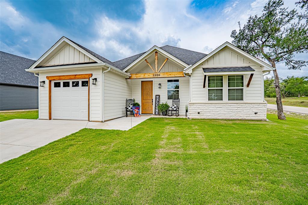 This stunning modern farmhouse sits on a corner lot and is loaded with thoughtful upgrades and timeless design elements that set it apart from the rest. Spray foam insulation keeps energy costs down and comfort levels high no matter the season. Step inside to discover a spacious open floor plan anchored by a striking custom 8ft wooden front door, soaring coffered ceilings, and durable ceramic tile flooring that flows seamlessly throughout the home. The kitchen is an entertainer's dream, featuring rich granite countertops and custom cabinetry that combine beauty with functionality. The master suite offers a true escape, boasting a luxurious walk-in shower and an expansive walk-in closet. Out back, a covered patio overlooks a generously sized backyard — the perfect setting for morning coffee or weekend gatherings. From top to bottom, this home reflects a level of craftsmanship and character that simply has to be seen in person. Call today to schedule your tour.