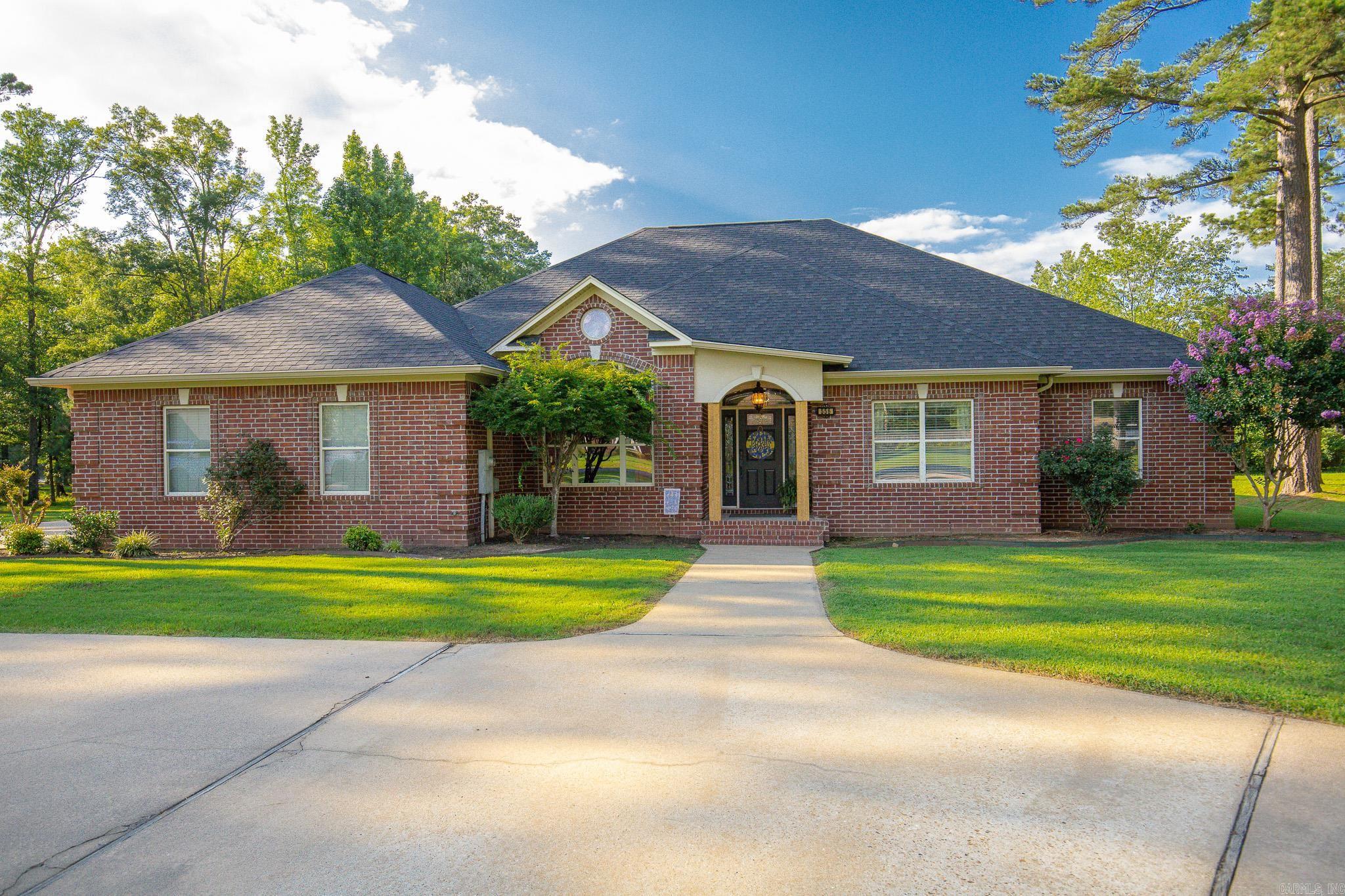 Spacious custom brick home on a fenced 0.75-acre lot offering approximately 2,689 heated and cooled square feet, plus a 360 sq. ft. heated and cooled bonus room with a half bath and a 495 sq. ft. heated and cooled garage. This versatile floor plan offers up to 5 bedrooms, 2 full baths, and 2 half baths. Inside, you’ll find beautiful wood floors, soaring ceilings, and an oversized family room with built-ins and a tray ceiling. The kitchen features granite countertops, abundant cabinetry, a gas cooktop, and a breakfast area. A gas fireplace highlights the den/game room, while the formal dining room has been converted into a spacious bedroom. The oversized primary suite includes a sitting nook, walk-in shower, Jacuzzi tub, and dual vanities. Additional features include a safe that conveys, two water heaters, and a 4-zone thermostats for added comfort. Built in 2003, this home offers exceptional flexibility with bonus space perfect for a guest suite, office, gym, game room, or workshop. A rare opportunity with room for everyone and everything! Sprinkler system for landscaping. Appliances stay