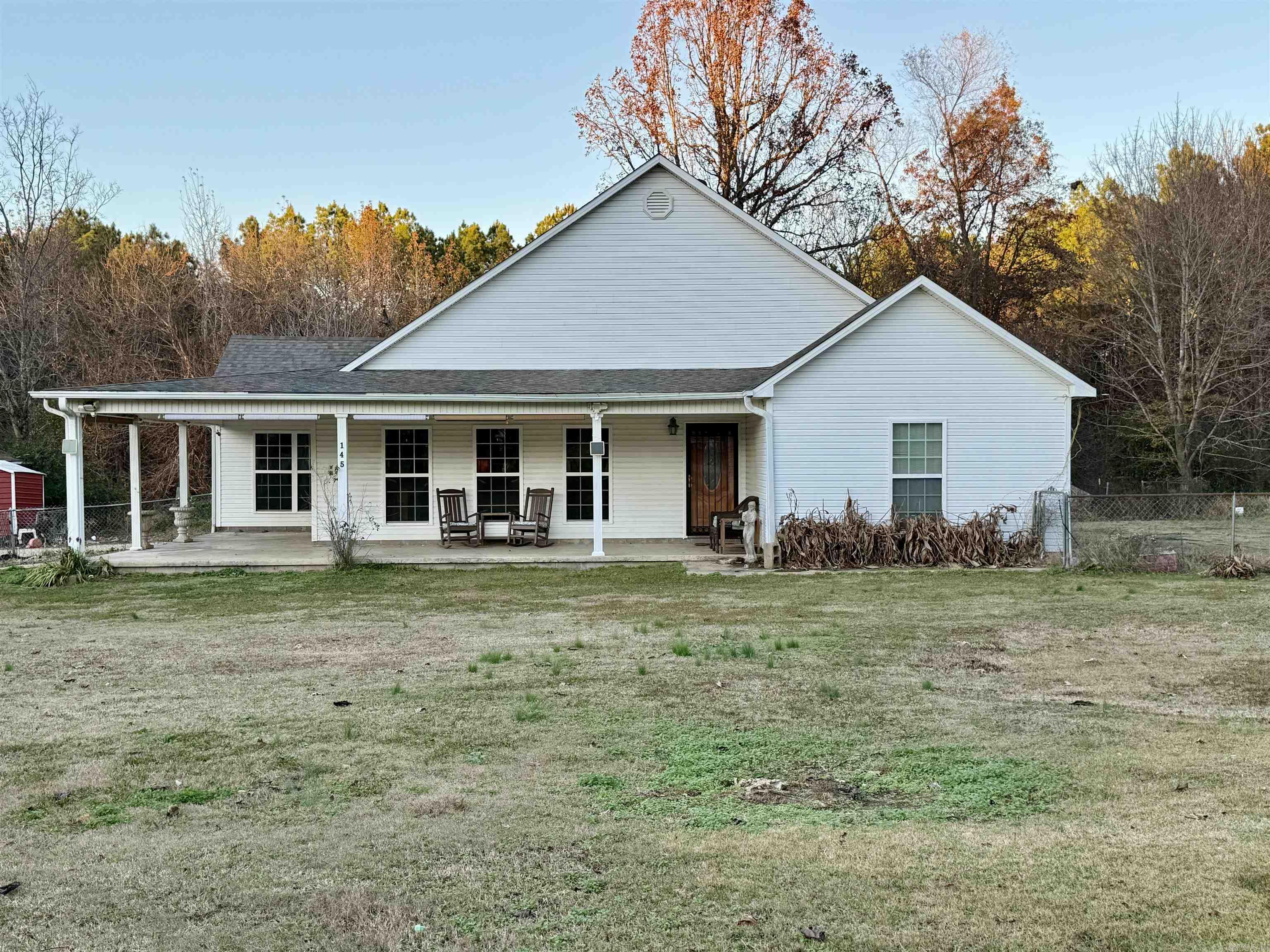 If you've been dreaming of peaceful country living, this is your opportunity. Nestled among mature trees and surrounded by nature, this charming home offers the privacy and tranquility you've been searching for while still being conveniently located near Jonesboro.  Inside, you'll find an inviting open floor plan with new LVT flooring, tall ceilings, spacious living areas, and a beautiful stone fireplace that creates a warm and welcoming atmosphere. The kitchen features ample cabinet space, a center island, and a dining area perfect for everyday meals or gathering with family and friends.  The primary suite offers plenty of room to relax, along with a walk-in shower and convenient access to the rest of the home. Additional bedrooms provide flexibility for family, guests, a home office, or hobby space.  Step outside and enjoy the wide front porch, fenced yard, mature shade trees, and peaceful pond views. Whether you're sipping coffee in the morning or unwinding after a long day, you'll appreciate the quiet setting and abundant wildlife.  Come experience the slower pace and simple beauty of country living at 145 County Road 778—a place you'll be proud to call home.