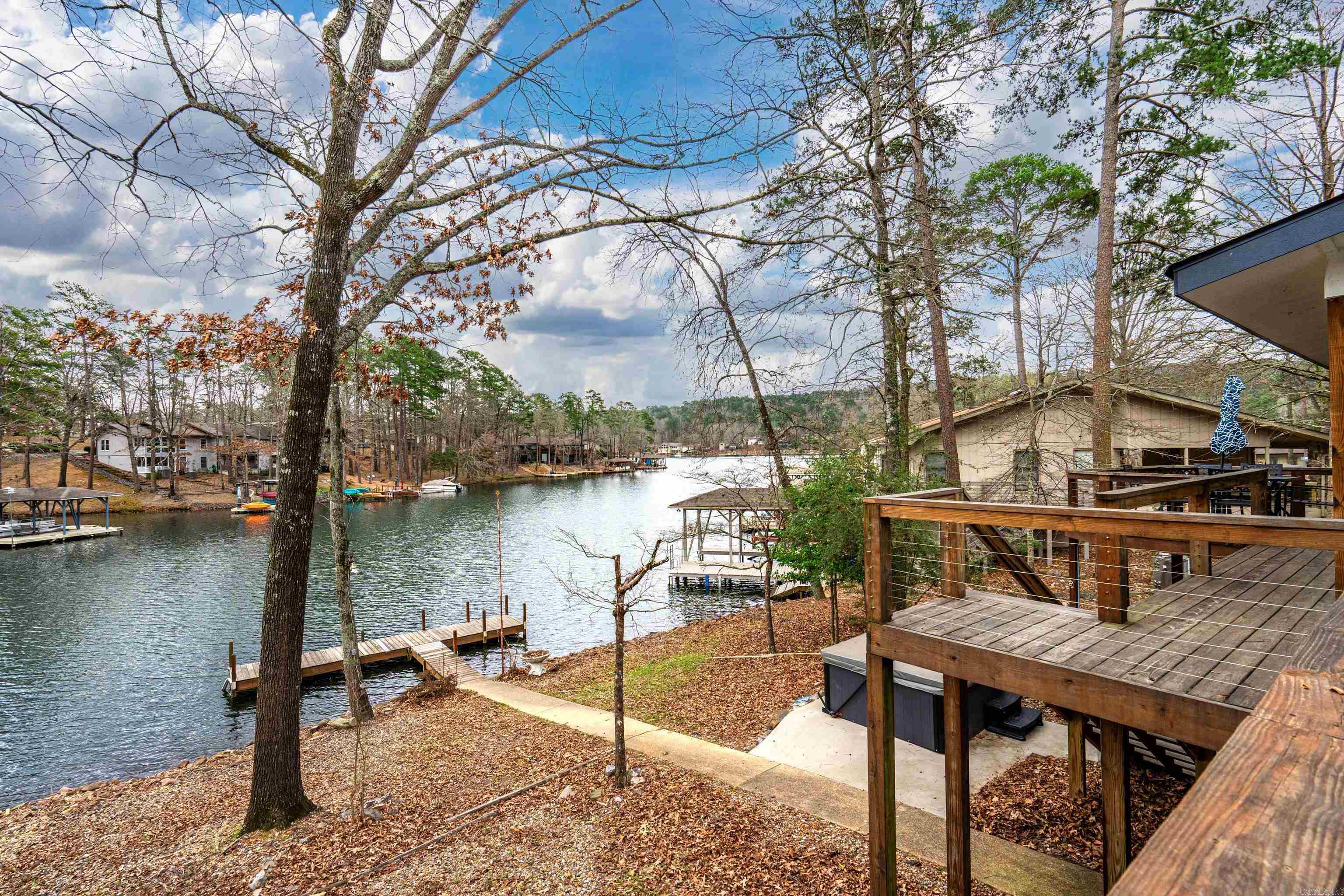 Welcome to 9 Madrid Way in beautiful Hot Springs Village, Arkansas - an incredible lakefront opportunity on the shores of Lake DeSoto. Recently renovated, this inviting home blends modern updates with the relaxed charm of lake living, creating the perfect retreat for both everyday enjoyment and entertaining.   One of the standout features of the 3 bedroom, 2 bathroom property is its incredible multi-level docks overlooking the water, offering stunning views of Lake DeSoto and the perfect setting for morning coffee, sunset gatherings, or simply soaking in the peaceful surroundings. A private swim dock provides direct access to the lake, making it easy to enjoy swimming, kayaking, or a day out on the water.   Whether you're searching for a serene personal lakefront getaway or a valuable vacation rental investment in the highly desirable Hot Springs Village community, this property offers the ideal combination of location, lifestyle, and opportunity.