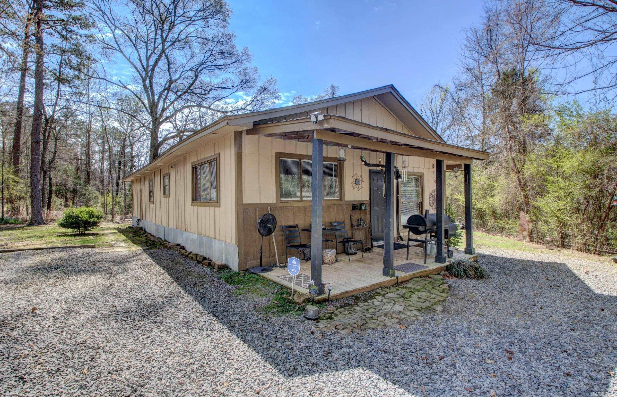 Adorable Cozy Cabin that you will fall in love with. Enjoy country living on an acre of land and having space between your neighbors. Front Porch offers a warm welcome and just relaxing. 4 bedrooms 2 baths. 1248 SF Living Space. House sits on 0.80 Acre Land approximately. Completely remodeled and updated, plumbing and electrical. New pex water lines for plumbing and new electrical wiring, new electrical outlets and  electrical panel, new walk in shower in Primary Bathroom. French Doors in Spacious Primary Bedroom.  New remodeled kitchen and both bathrooms updated. Flooring tile in bathrooms, vinyl and LVP throughout. New Paint all over. New water heater. 4 Mini-split's heat and cooling units that you can control separately or together. New Architectural Roof, New Kitchen Appliances. Move In Ready. All Electric Utility. City Water and Septic Tank for sewer. Refrigerator, Washer and Dryer Convey with the property at Closing. Measure square footage for accuracy. Nice sized backyard. Chain Link Fence on front of property. 5 minutes to Interstate I-40, shopping, schools, churches and restaurants.