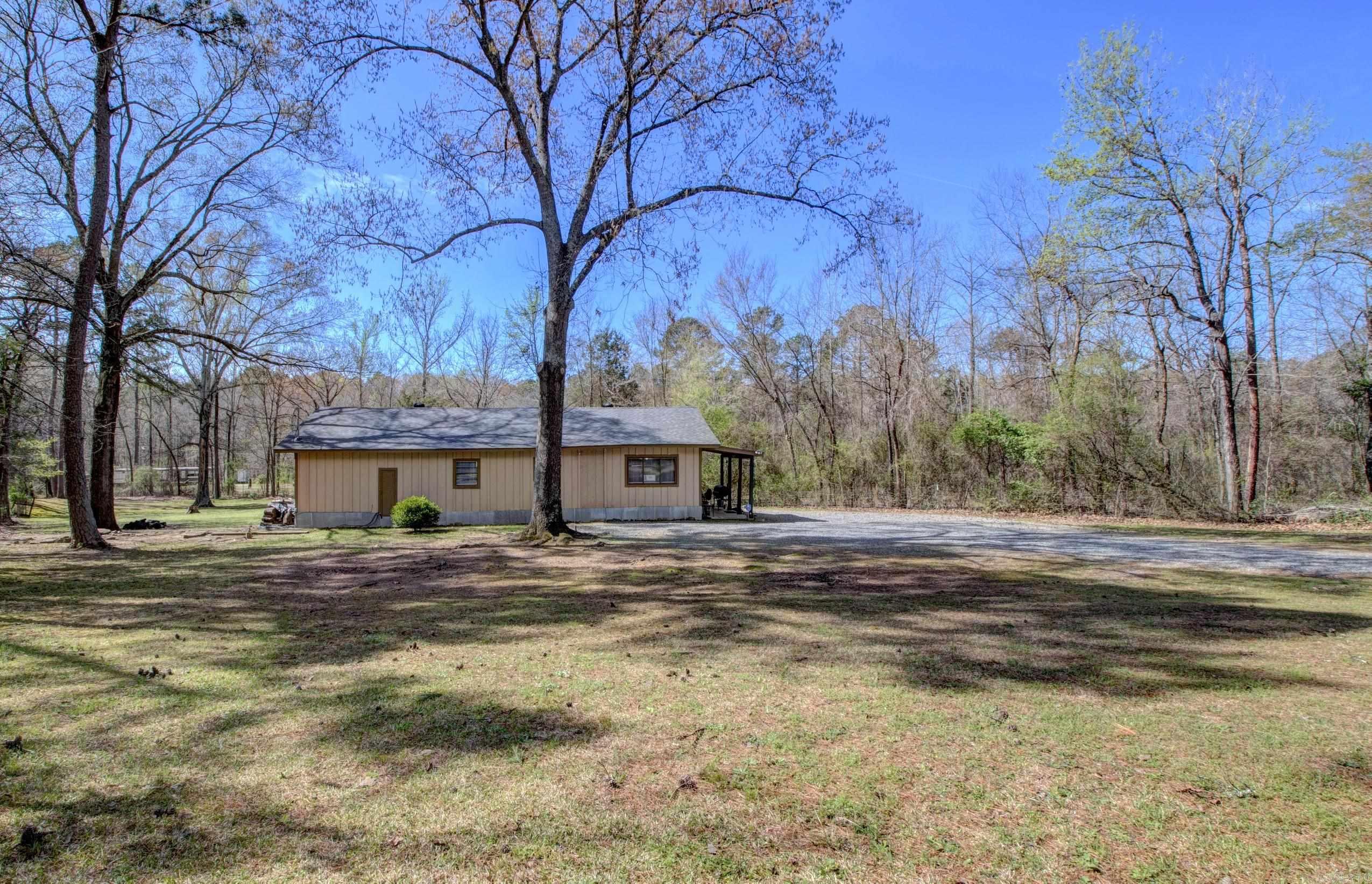 Adorable Cozy Cabin that you will fall in love with. Enjoy country living on an acre of land and having space between your neighbors. Front Porch offers a warm welcome and just relaxing. 4 bedrooms 2 baths. 1248 SF Living Space. Primary bedroom and 1 other are good sized rooms. Other 2 bedrooms are quite smaller. House sits on 0.80 Acre Land approximately. Completely remodeled and updated, plumbing and electrical. New pex water lines for plumbing and new electrical wiring, new electrical outlets and  electrical panel, new walk in shower in Primary Bathroom. French Doors in Spacious Primary Bedroom.  New remodeled kitchen and both bathrooms updated. Flooring tile in bathrooms, vinyl and LVP throughout. New Paint all over. New water heater. 4 Mini-split's heat and cooling units that you can control separately or together. New Architectural Roof, New Kitchen Appliances. Move In Ready. All Electric Utility. City Water and Septic Tank for sewer. Refrigerator, Washer and Dryer Convey with the property at Closing. Measure square footage for accuracy. Nice sized backyard. Chain Link Fence on front of property. 5 minutes to Interstate I-40, shopping, schools, churches and restaurants.