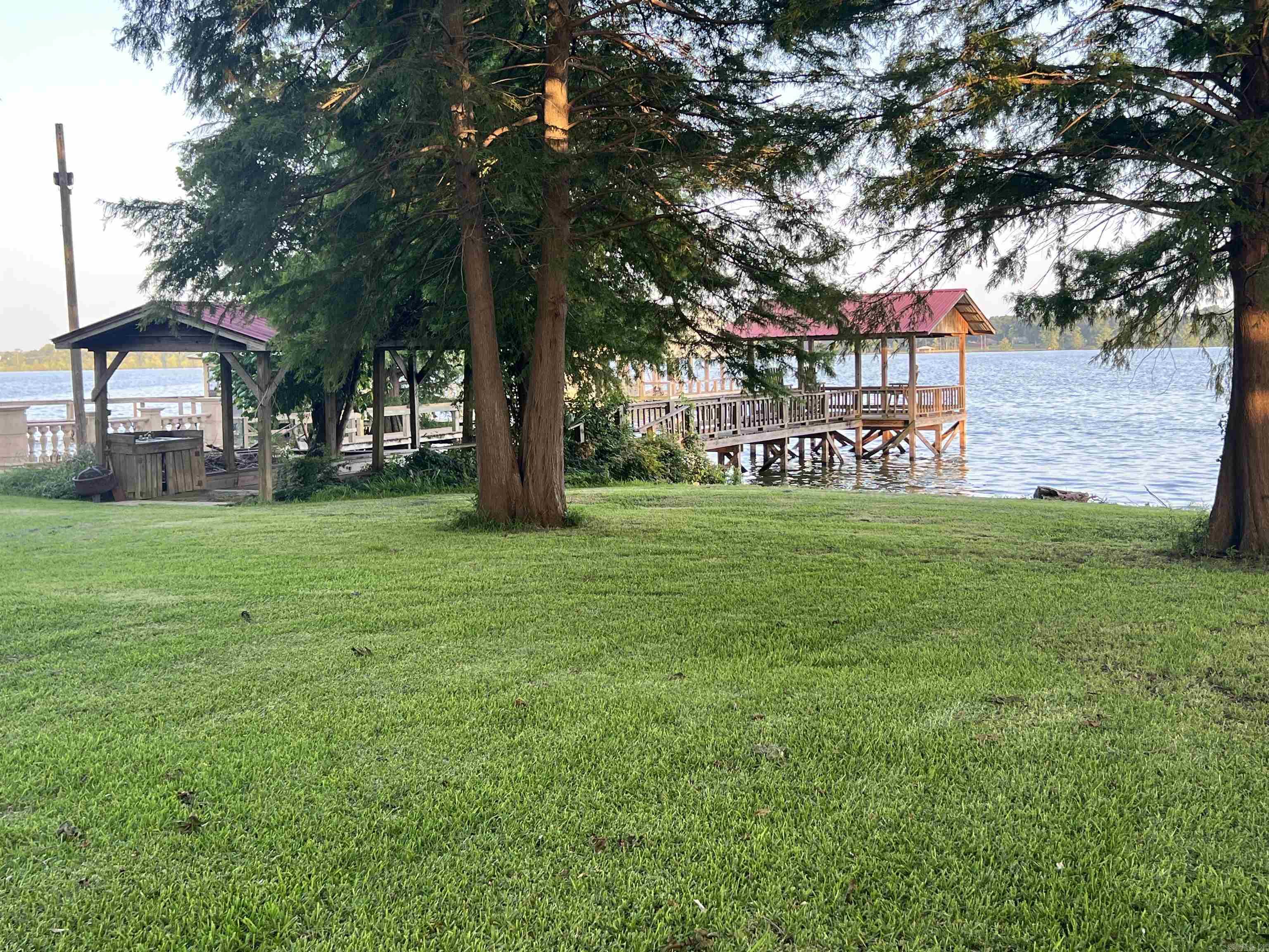 Rare opportunity to own a beautiful 100-foot lakefront lot on one of Southeast Arkansas’ most desirable lakes! This ready-to-enjoy property features a covered boat dock, separate fishing dock, and private boat slip, making it the perfect place for fishing, boating, skiing, or simply relaxing by the water.  The property is already equipped with underground utilities, water, and septic, giving you a head start on building your dream lake home or weekend getaway. With no HOA and no restrictions, you’ll have the freedom to create the lakefront retreat you’ve always envisioned.  Whether you’re looking for a peaceful escape, a recreational property, or the perfect homesite with stunning water views, this exceptional lakefront lot offers endless possibilities. Don’t miss your chance to enjoy lake living at its finest!