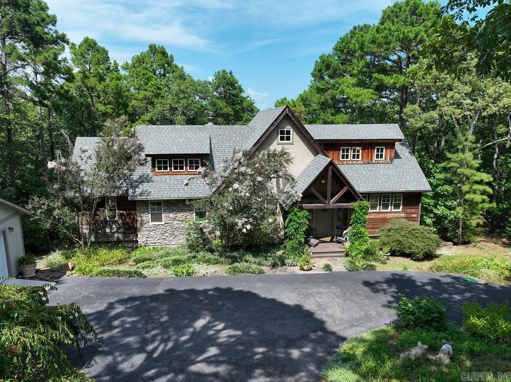 Beautiful timber frame home featuring a stunning rustic style interior with a vaulted ceiling of natural wood creating a warm cozy feeling, exposed wooden beams with rough-hewn floors add to the character and charm. The focal point of the room is the large wall of windows looking out over Greers Ferry Lake, with an easy walk to the water where you can relax on your own private shale beach! The kitchen is so inviting with windows looking out over the front of the landscaped yard with plenty of workspace! This home has 5 bedrooms, 4 1/2 bath, 3 living areas, 2 fireplaces, wet bar, new roof and circular driveway. This property is very unique and is the perfect setting for a peaceful getaway! Don't miss out on this one!!!!