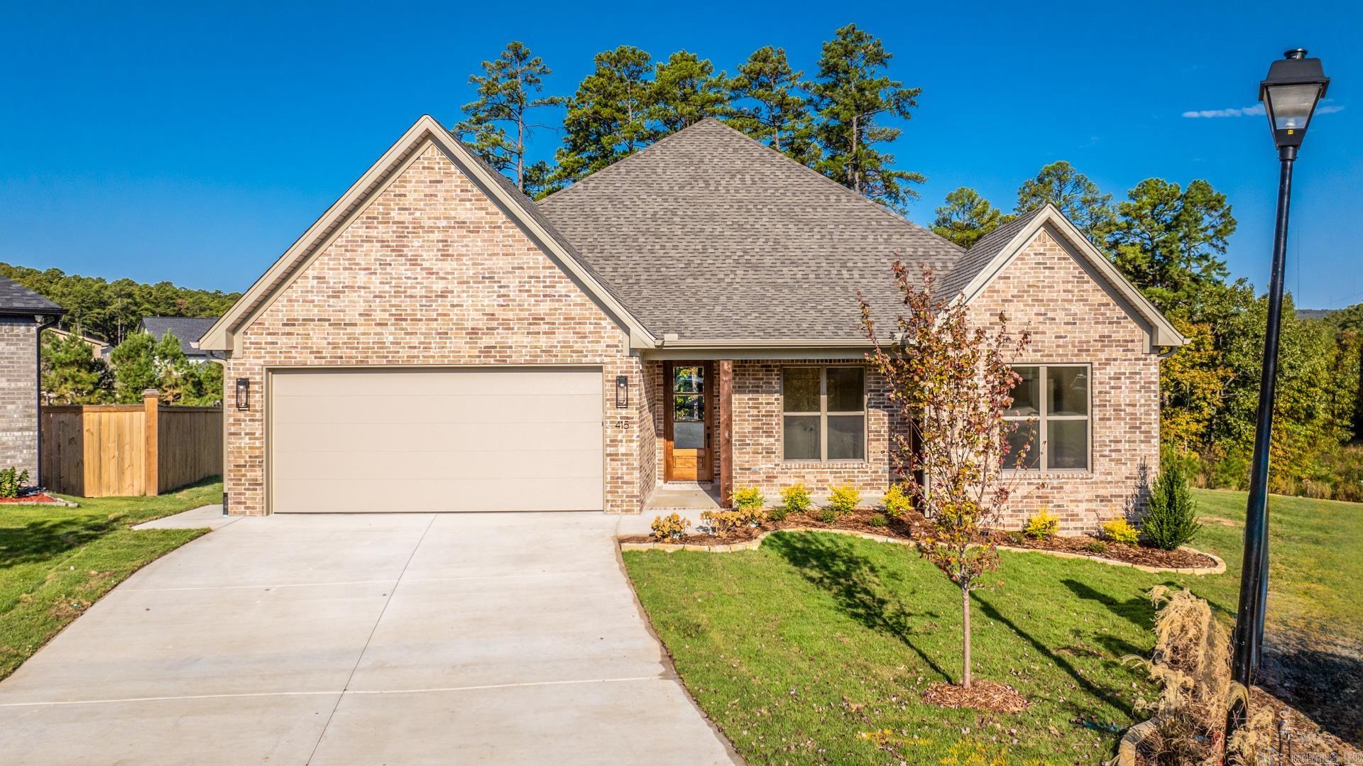 There's SO much to love about this Parkside at Wildwood home, thoughtfully designed by Graham Smith. Step inside to discover an open concept living area with tasteful designer finishes throughout. The spacious kitchen is the heart of the home and opens to the dining & living room which features a gas fireplace. The kitchen features custom built cabinets, stainless steel appliances, quartz countertops, a custom pantry and a large kitchen island with a breakfast bar. The primary suite is a retreat complete with an en-suite bath featuring a soaking tub, walk-in shower, and custom closet that is connected to the laundry room. Two additional bedrooms and a shared full bath offer plenty of space for family or guests. The office could easily be used as bedroom or playroom depending on your needs.The covered patio is perfect for enjoying the serene surroundings. This home backs up to a wooded area offering privacy. Enjoy this beautiful new home currently under construction with an estimated completion date of September 2024. Welcome Home!